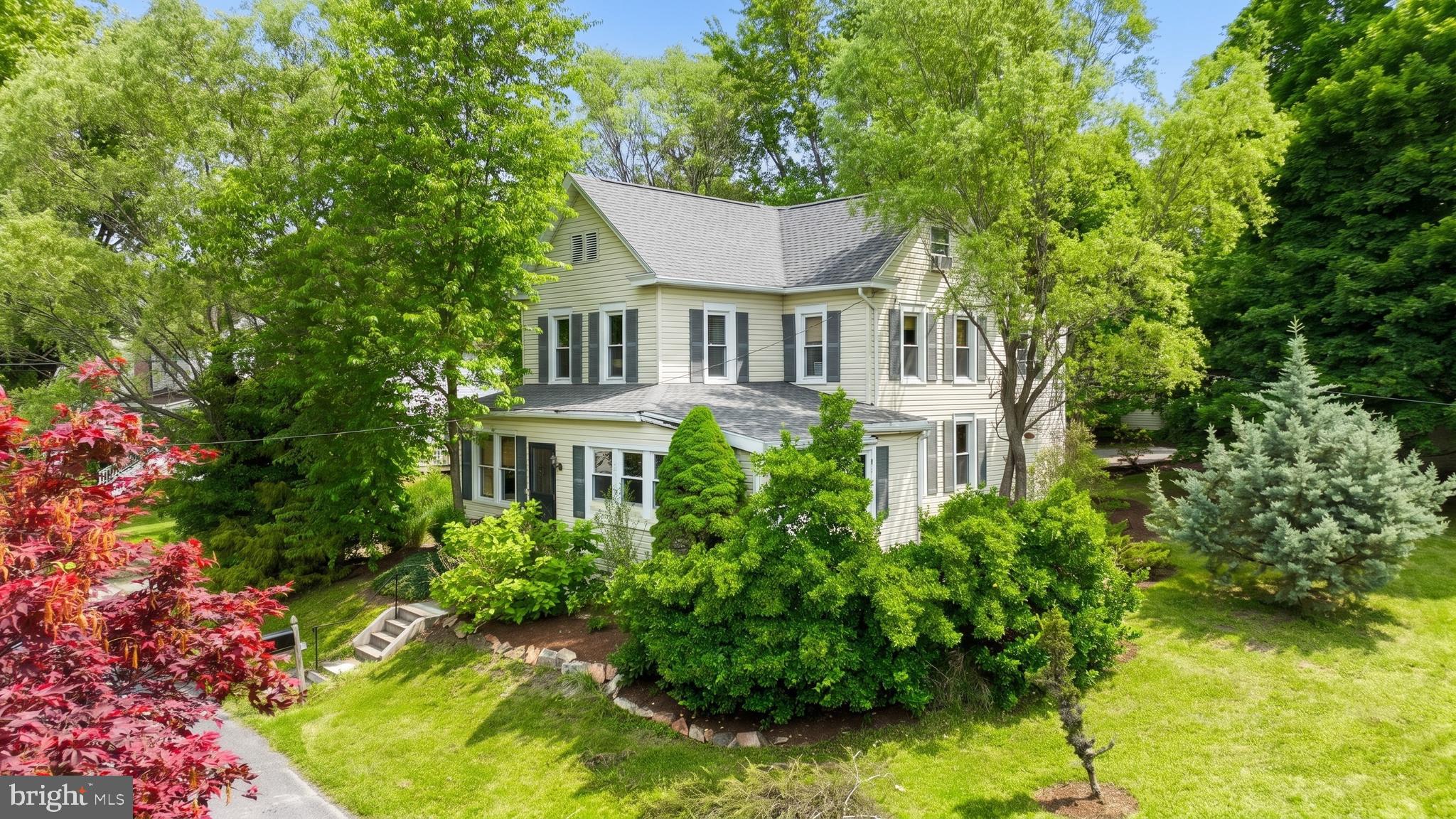 One-of-a-kind opportunity to own this traditional-style home situated on a private, tree-lined ¾-acre lot. Multiple outbuildings provide endless possibilities for workshop space, hobbies, equipment storage, or additional utility use. Inside, you’ll find a bright and open layout accented by beautiful hardwood flooring throughout much of the home. Offering three bedrooms, three full baths, and a convenient half bath, this home provides plenty of space for everyday living. The updated kitchen serves as the heart of the home and features a spacious center island along with direct access to the porch, making it ideal for entertaining. Just off the kitchen are the formal dining room and living room. The main level also includes a laundry area, half bath, and a functional mudroom with additional storage space. Upstairs, the primary suite features a private full bath, while a second bedroom and two additional full baths complete the level. The finished third floor offers a versatile space that can serve as a third bedroom, home office, or bonus room. Recent improvements include new insulation and an upgraded 200-amp electrical panel. this property offers a rare opportunity with endless potential.
