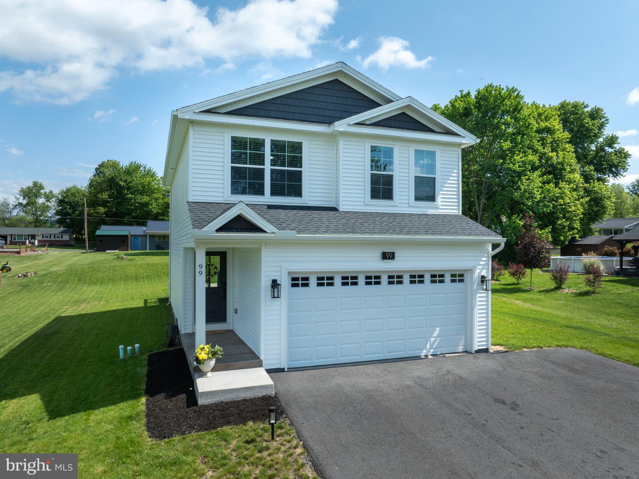 Welcome to 99 Hillside Drive! Built in 2024 this home offers modern finishes, thoughtful design, and comfortable everyday living. This 3-bedroom, 2.5-bath home features an open and inviting layout with central A/C, stylish finishes, and plenty of natural light throughout. The kitchen is equipped with stainless steel appliances, sleek cabinetry, and ample workspace, flowing seamlessly into the main living area and dining space. Upstairs, the spacious owner’s suite offers a private en suite bath. Step outside to enjoy the rear deck overlooking the generous 0.39-acre lot — perfect for entertaining, outdoor dining, or simply enjoying the peaceful setting. Additional highlights include a 2-car garage and an unfinished basement offering endless possibilities for future expansion, storage, or a custom recreation space. Move-in ready and thoughtfully designed, this like-new home combines comfort, style, and functionality in one beautiful home.