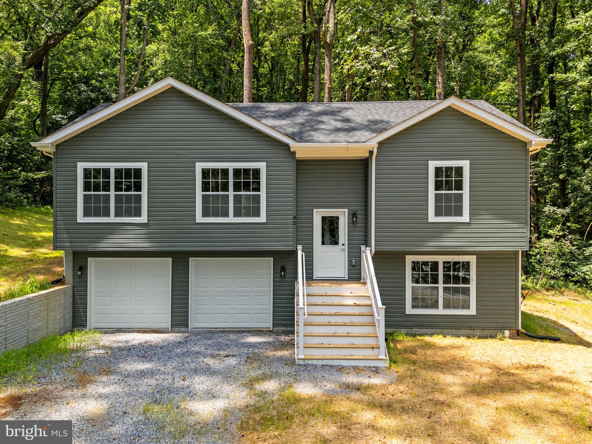 New construction in Shannondale, offering a move-in ready split-level home on a wooded lot just minutes from Lake Shannondale and Mountain Lake Club. Built with attention to detail, this home is an excellent choice for commuters looking to enjoy the beauty of West Virginia without sacrificing convenience.

Natural light fills the open main level, where the living room, dining area, and kitchen create an inviting space for gathering. The kitchen features a center island, farmhouse sink, soft-close cabinetry with a lazy susan, recessed lighting, and views of the backyard. Luxury vinyl plank flooring, ceiling fans, detailed trim, and window screens add comfort and functionality throughout the home.

The layout includes three bedrooms and three full bathrooms, including a primary suite with a walk-in closet and private bath. The finished lower-level family room offers additional living space with direct access to the backyard. A two-car garage provides plenty of room for parking and storage.

Located near the Appalachian Trail, this home offers easy access to hiking and outdoor recreation. Lake Shannondale and Mountain Lake Club are just a short drive away, where a 55-acre lake and 25 acres of shoreline provide year-round opportunities to enjoy the outdoors. Whether you're looking for your primary residence or a weekend escape, this home offers a comfortable setting with easy access to both nature and nearby commuter routes.