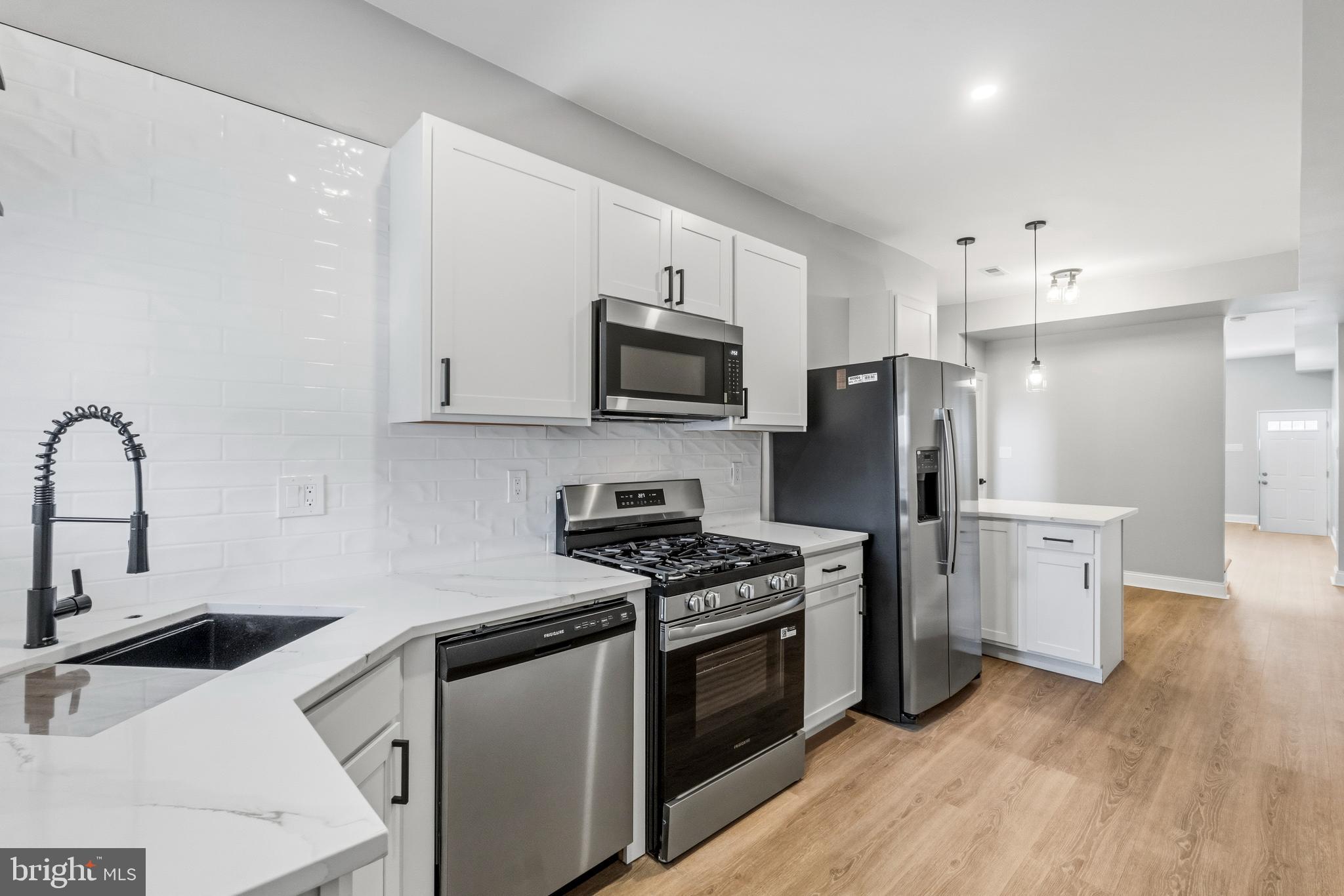 Oliver neighborhood welcomes you to this gem. Come and experience the charm of this just renovated townhouse. This home seamlessly blends historic character with modern comfort. With five spacious bedrooms and three and a half bathrooms, there's ample room for everyone. Hardwood floor and all stainless steel appliances. 
Enjoy the convenience of off-street parking within a private, fenced area. The inviting layout is perfect for small gatherings, while the intimate outdoor space provides a serene retreat. Located in a vibrant community, you'll find local shops, parks, and dining just moments away. A few minutes to Downtown, Fells Point and Upper Fells point. This home is a place to live and create lasting memories. Experience the warmth, comfort and charm it offers. Your new beginning awaits!