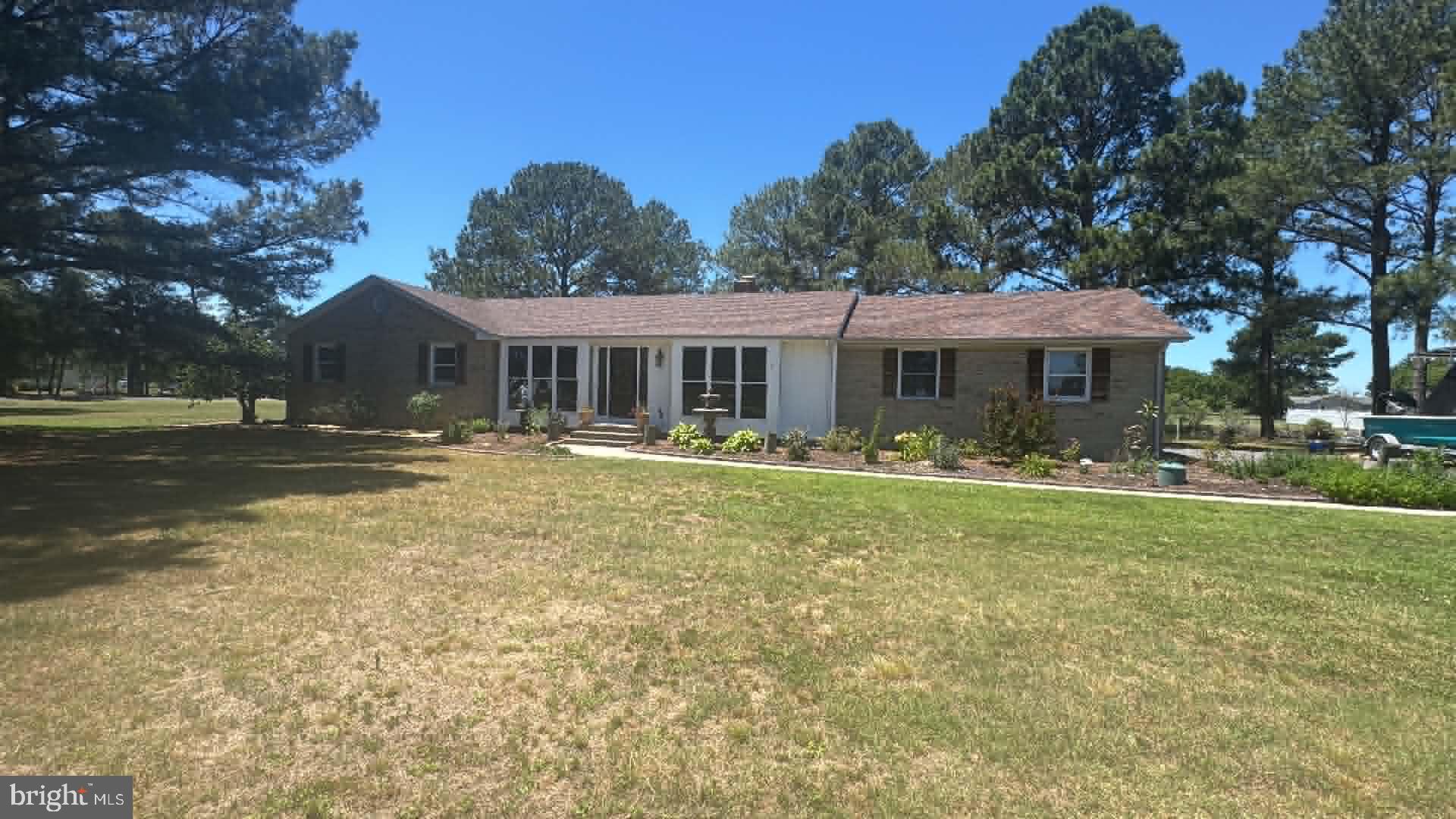 Welcome to this beautifully maintained brick ranch home situated on a canal-front double lot at the end of a quiet cul-de-sac, offering privacy, space, and waterfront living at its finest.
This spacious home features 3 bedrooms, 3 full baths, and 1 half bath, including a huge primary suite with a private en suite bath. The inviting living area showcases a stunning brick fireplace with a woodstove insert, creating the perfect cozy gathering space.  New wood flooring that flows throughout the home, complemented by custom wood blinds and multiple ceiling fans for comfort and style.
The bright and airy sun room is a true highlight, featuring six sliding glass doors with screens that open to a brand-new deck complete with built-in self-watering planters (removable) — ideal for entertaining or relaxing while enjoying serene canal views.
The kitchen was updated in 2022 with new cabinetry, and the home continues to impress with thoughtful upgrades throughout, including: Brand-new roof (2023), New carriage-style garage door with new tracks and Bluetooth-enabled openers with remotes, Screened-in attached patio gazebo, Oversized dock with a private boat ramp, Continuous pest and rodent protection contract with Terminix, Dry-lock system installed under the home (guaranteed by Terminix), Furnace and AC professionally cleaned and serviced annually by Morrow’s, and New attic caps installed in 2025.
The beautifully landscaped yard enhances curb appeal, and the one-and-a-half car garage offers additional storage space. Located in a peaceful neighborhood with a minimal HOA fee of just $75 per year, this property combines modern updates, waterfront amenities, and long-term maintenance care — providing peace of mind for years to come. This exceptional canal-front retreat truly has it all — space, upgrades, and location. Please note that the square footage from the sun room and master is not encluded in the total square footage of the home.