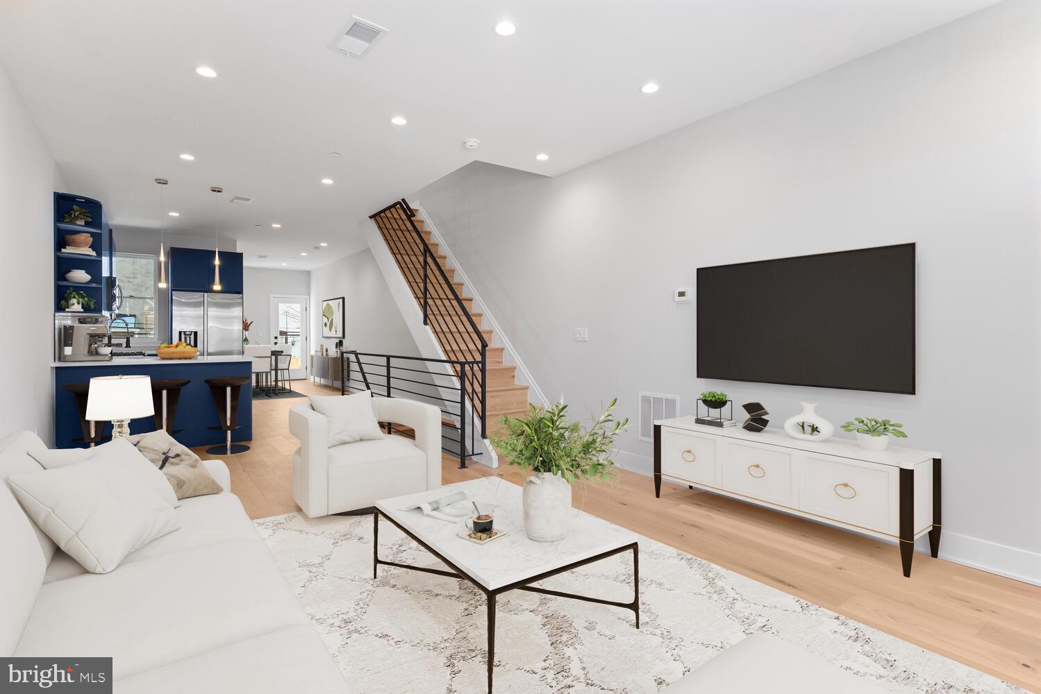 New construction two-story home with a finished basement located on a quiet block in West Philadelphia. The first floor offers a large living room, kitchen, and dining area with great natural light from side windows and direct access to the backyard. The kitchen features stainless steel appliances, quartz countertops, recessed lighting, and 5-inch hardwood plank floors. A generous front porch provides additional outdoor space.

The finished basement includes one bedroom, a den or office, a full bathroom, and additional living space, offering flexible use for guests, work-from-home needs, or recreation.

The second floor features a rear bedroom with a large closet and access to a full bathroom, which is also accessible from the hallway. Laundry is conveniently located on this level with full-size front-loading machines. The front primary bedroom includes high ceilings, two closets, and a primary bathroom with a double vanity and rainfall showerhead.

Hardwood floors run throughout the home. Additional features include central heating and air conditioning and a modern, functional layout. A well-designed new construction that stands out in the neighborhood.