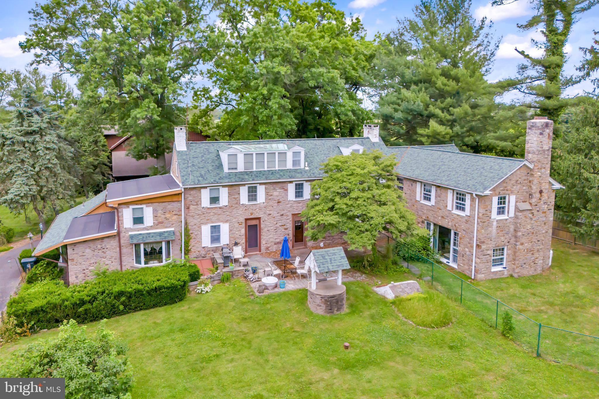 Property has been chosen as the Bucks County Designer House.  Discover a rare gem with this charming 1700s farmhouse, nestled on 14.70 acres of picturesque land. As you enter the gated estate, flanked by stone walls, a wishing well accents a sprawling yard a babbling brook flows by. This extraordinary property features two homes, offering a unique blend of historic character and modern flare. The beautiful 5000 sf main house features a welcoming front porch, 3 fireplaces, 6 bedrooms including a master suite with extensive closets and a built-in vanity, 6 bathrooms, hardwood floors or tiles throughout, a stunning majestic bar, a jacuzzi tub, and a huge picture window. 

The second house takes second place to no one!  Custom-designed in 1992, this impressive home combines the coziness of a 3-story stone fireplace with the perfect set up for entertaining guests.  Granite countertops gleam throughout the galley-style kitchen and bar.  Tigerwood flooring and travertine tiles cover most of the house.  The master bedroom has 2 walk-in closets and built-in cabinets/dressers.  The second bedroom has a loft area above built-in bookshelves.  There are 3 full bathrooms, including one with a steam shower and one with heated flooring. The finished walk-out basement includes a sauna and a spa room, with a hot tub that can accommodate 12 people.  Surrounding the house is multi-level Trex decking with a screened-in gazebo and built-in grilling area which has stainless steel cabinets and a gorgeous granite countertop.  The balcony off the master bedroom overlooks a newly renovated pool and patio, as well as a stunning koi pond with a waterfall! The kitchen featuring granite countertops, perfect for culinary enthusiasts, the living room is a cozy and inviting space centered around a stunning 2-story stone fireplace, open loft area and second floor bedroom with a balcony ideal for a home office, reading nook, or additional living space.

 Off the main house is a multi-level decking with a gazebo and built-in grilling area, all overlooking the pool so you can enjoy summer days lounging by your private pool.. The multi-level former barn, once used as a kennel, offers potential for various uses. The property also has a pole barn for additional storage or workspace to suit your needs. 

This unique property is a must-see! Schedule an appointment today to explore the incredible potential and charm of this historic estate. This estate is more than just a home; it's an opportunity to own a piece of history while creating your future.