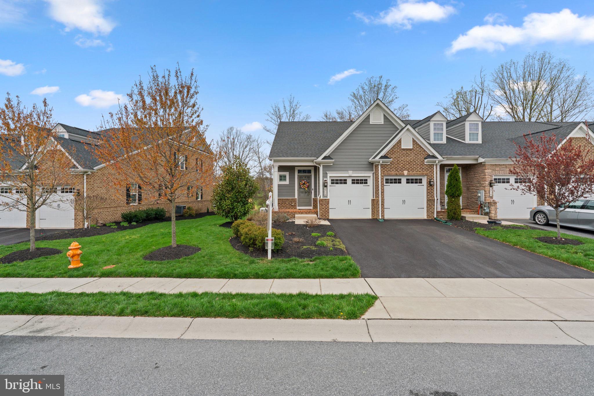 Welcome to this beautifully maintained brick-accented villa, built in 2018 and nestled in the sought-after Fairways at Turf Valley. Backing to the scenic golf course and enhanced by thoughtfully designed landscaping, this home has been lovingly cared for by its original owners. With an HVAC system installed in 2023 and updated hardwood floors gracing most of the main and upper levels, comfort and style come effortlessly.

Inside, the home showcases elegant interiors with luxury finishes, tasteful pops of color, and a layout designed for modern living. Step into the foyer, where a chic powder room sets the tone, and follow the hallway to the bright, open-concept living spaces. The gourmet eat-in kitchen is a true showstopper, featuring a large center island with pendant lighting and seating, quartz countertops, stainless steel appliances, a classic subway tile backsplash, a pantry with a Chesapeake Closets® system, and a dining area complemented by a butler’s pantry with glass-front cabinetry. Just off the kitchen, the laundry room provides convenient access to the attached garage. The living room exudes charm with an electric fireplace framed by custom built-ins, a coffered ceiling, and access to the covered porch—perfect for indoor-outdoor living. The main-level owner’s suite is tucked away through an arched hallway and offers a tray ceiling, private access to the covered porch, a spa-inspired ensuite bath with a long double vanity, an oversized shower with a built-in bench, and a walk-in closet outfitted with a Chesapeake Closets® organization system.

Upstairs, a versatile loft and bonus study area behind French doors provide ideal spaces for work or play. Two spacious bedrooms each feature walk-in closets and share a well-appointed full bathroom with double sinks. A large storage room adds extra functionality. The finished lower level expands the living space with durable LVT flooring, a walk-up exit to the backyard, a full bathroom, a flexible bonus room behind French doors, and additional storage areas.

Out back, enjoy serene views of the lush, irrigated lawn and picturesque golf course from the comfort of your covered porch—a peaceful retreat for quiet mornings or evening gatherings. The garage has been thoughtfully designed with a custom Chesapeake Closets® system as well.