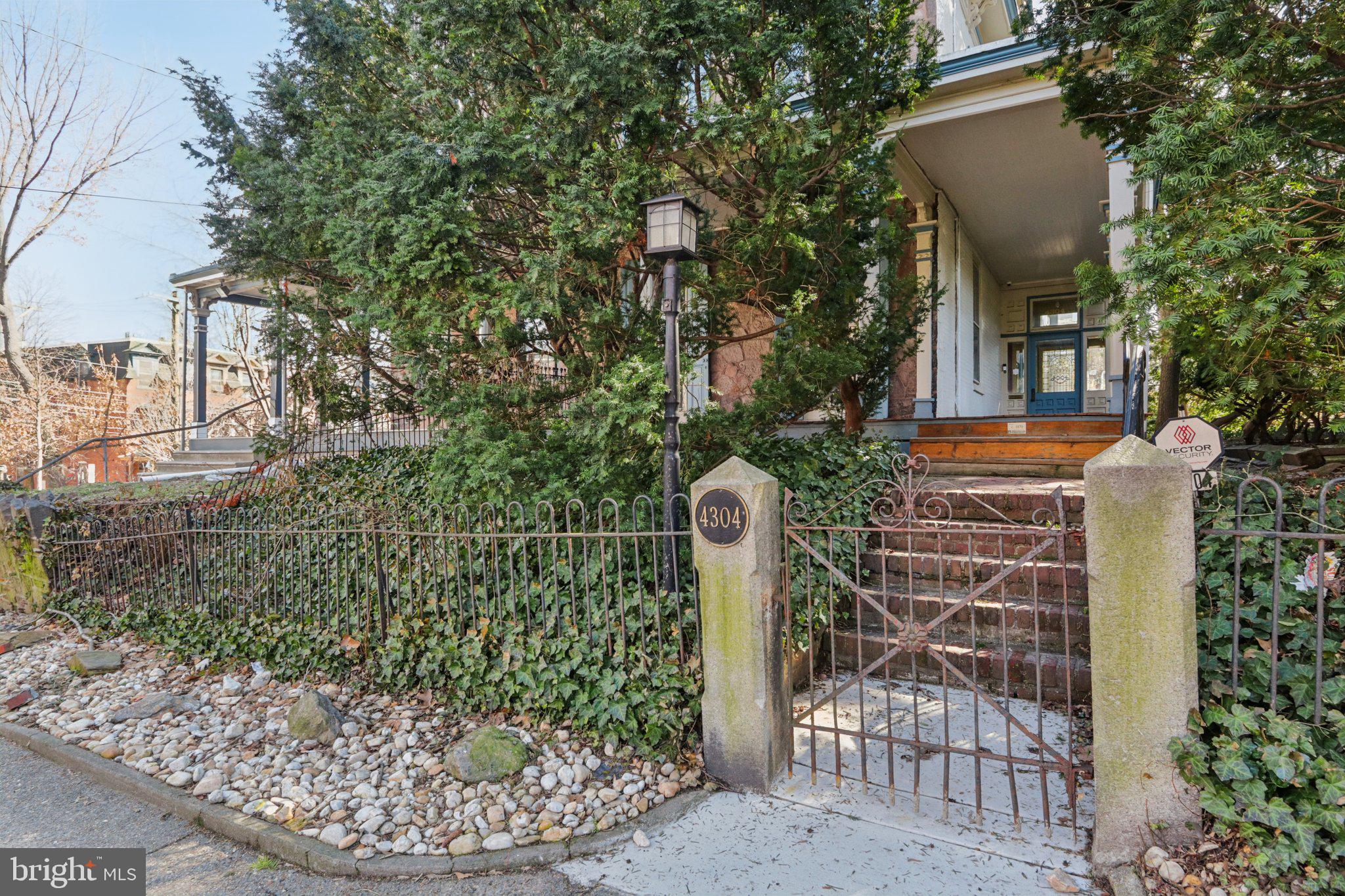 Beautiful historic twin on a double lot with PARKING on one of the Penn Alexander Catchment’s most desirable tree-lined blocks. c.1870. 5 bedrooms plus a family room, 2.5 baths. Incredible outdoor space that includes a wraparound porch, front garden, large rear patio/garden, and a huge side garden/patio/wooded area that sits on the double lot. This home offers stunning character such as towering ceilings; capacious spaces; oversized windows; original hardwood floors; moldings and wainscoting; and a charming, eclectic (yet practical) layout. Ample light from three exposures including the open southern views from the rear and the west along the spacious side-yard.

The 1st floor offers a private entry vestibule that opens into a center hall. A large living room, separate dining room, and spacious south-facing eat-in-kitchen. The 2nd floor with two very large bedrooms, a family room and full bath (or primary suite, family room , and den/office). The 3rd floor offers three more bright bedrooms and a full bath. Very spacious dry basement for significant storage. Excellent storage throughout as well. Newly rewired to replace all knob & tube, as well as new electrical box. Main floor laundry.

This warm and wonderful home with incredible light and character (and driveway parking) is located on a historic Spruce Hill block in the PENN ALEXANDER CATCHMENT. An ideal location—Easy walk to the school, Clark Park and its fabulous Farmers' Market, Knockbox Cafe, Green Line Cafes, ReAnimator Coffee, Baltimore Avenue's Restaurant Row (so many places to eat), Don Barriga Mexican Grill, Doro Bet, Clarkville, Gojjo, TacoTaco Mexican, Local 44 and the Bottle Shop, CVS, and so many coffee shops, restaurants, and shopping. Close to HUP, CHOP, Penn, Drexel, UCity Tech/Science Corridor. 94 WalkScore!! 12 minutes to Center City by car or bike and plenty of convenient SEPTA options.

NOTE—This stunning home is both individually designated on the Philadelphia Register of Historic Places and situated in the Satterlee Heights Historic District.