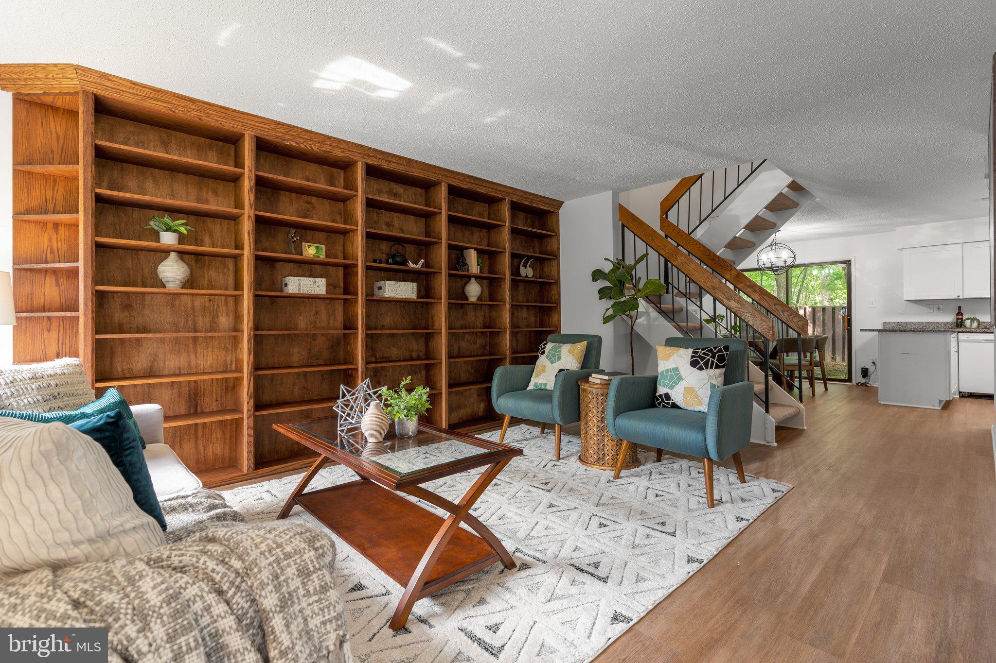 This is it, a wonderfully updated townhome just off Sunrise Valley Drive for the price of a nearby condo! Just over a mile - a quick walk or bike ride - from the Reston Town Center Metro station, this contemporary Reston beauty offers a convenient location near the Dulles Toll Road, Wegman’s and all the shops and restaurants in the Reston Town Center. Step inside and you will find a separate entry foyer with a powder room, a spacious living room, and an updated kitchen with granite countertops, a breakfast bar, and a dining area. Up one level is the primary bedroom, 2 additional bedrooms and a full bath. Outside, the fenced yard offers a private outdoor space with plantings and stepping stones, and the generous open space behind the home provides screening and leafy, forested views. The front yard features mature blueberry bushes that yield a harvest each summer and an established gardenia bush is profuse with fragrant blossoms from spring through to the end of fall. Recent improvements make this home truly move-in ready. Enjoy peace of mind for years to come with a brand-new roof (2024) and a new washer/dryer unit. Other updates including new indoor lighting, LVP flooring throughout, and solid red oak custom built-in bookshelves that enhance the home’s value. Trash pickup, snow removal and use of all the great Reston amenities (tennis & pickleball courts, pools, trails and gardens) is included in the low HOA fee plus 2 assigned parking spaces. Welcome home!