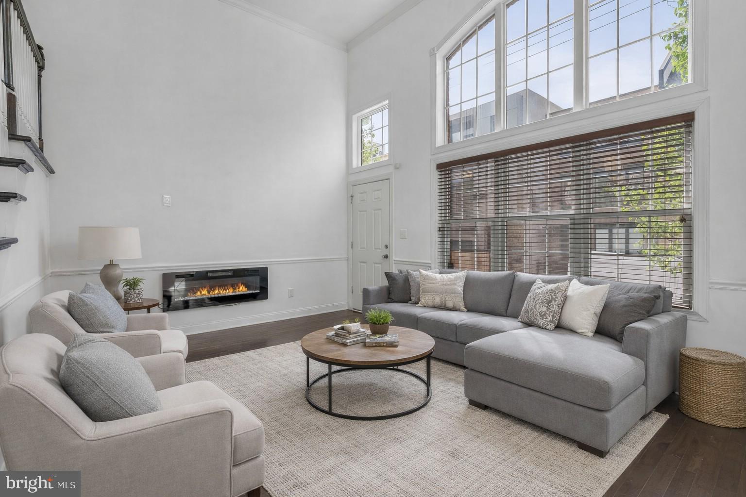 Welcome to this exceptional home in the sought-after Liberty Greene community in Northern Liberties, complete with coveted garage parking. This striking residence blends classic brick frontage with modern, sophisticated design. Step inside to a dramatic living room featuring soaring 14-foot ceilings and abundant natural light. A short flight of stairs leads to the dining area and kitchen, thoughtfully positioned to overlook the living space—offering both an open-concept feel and defined living areas. The kitchen provides access to a private balcony, perfect for grilling and entertaining. The second floor includes two generously sized bedrooms, a full hall bath, and convenient laundry. The entire third level is dedicated to an expansive owner’s suite with a spa-inspired bath, two oversized walk-in closets, and a private balcony showcasing sweeping city views. A fully finished basement adds flexible living space, and the unbeatable location places you just steps from Liberty Lands Park, Liberties Walk, and an array of popular cafes, restaurants, and neighborhood amenities. This is a rare opportunity to own a beautifully designed home in the heart of Northern Liberties. Taxes and square footage is the responsibility of the buyer to have verified independently.