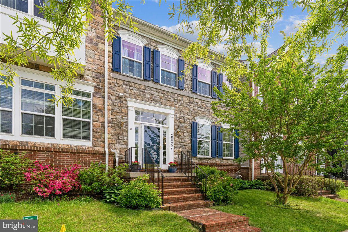 Don't miss this beautiful 24-foot-wide stone-front townhome built by K Hovnanian Homes and located directly across from Arora Hills Park in the sought-after Greenway Village community of Clarksburg. This spacious home offers 3 bedrooms, 3.5 baths, and three finished levels with nine foot ceilings designed for comfortable living.  **  The main level welcomes you with an entry foyer, living room, separate dining room, and a spacious kitchen featuring stainless steel appliances, a walk-in pantry, and an open layout that flows into the family room with a gas fireplace. Hardwood flooring extends throughout the main level. The powder room is also conveniently located on this level.  **  Just off the kitchen, a large renovated deck (2024) provides the perfect spot to enjoy your morning coffee or unwind after a busy day.  **  Upstairs, the generously sized primary suite includes a large walk-in closet, en-suite bath with a double vanity, soaking tub, and separate shower. Two additional generously sized bedrooms with large closets and a hall bath with dual sinks and a tub/shower combination complete this level. The washer and dryer are conveniently located on this level as well.  **  The walk-out lower level features a large recreation room, a full bath added in 2018, and two bonus rooms ideal for offices, hobbies, or flexible living space.  A newly installed  patio (2024) offers a relaxing outdoor retreat.  **  The fenced backyard is connected to a detached two-car garage with cathedral ceilings by a new flagstone walkway (2024).  **  This lovely home is equipped with two-zone heating and cooling for added comfort and efficiency.  **  Enjoy an exceptional location across from the county park and take advantage of the outstanding amenities of this Clarksburg community, among them outdoor swimming pools, playgrounds, common areas, and walking/jogging trails. The close by and recently renovated Ovid Hazen Wells Park features a skate park, carousel, playgrounds, swings, picnic areas, and more.  As an added convenience the  elementary and high school bus stops are in front of the home, and the middle school is just two blocks away.  A further plus is the close proximity to commuter routes, shopping, dining, and a variety of recreational opportunities. This beautiful home and the community offer a most appealing lifestyle.