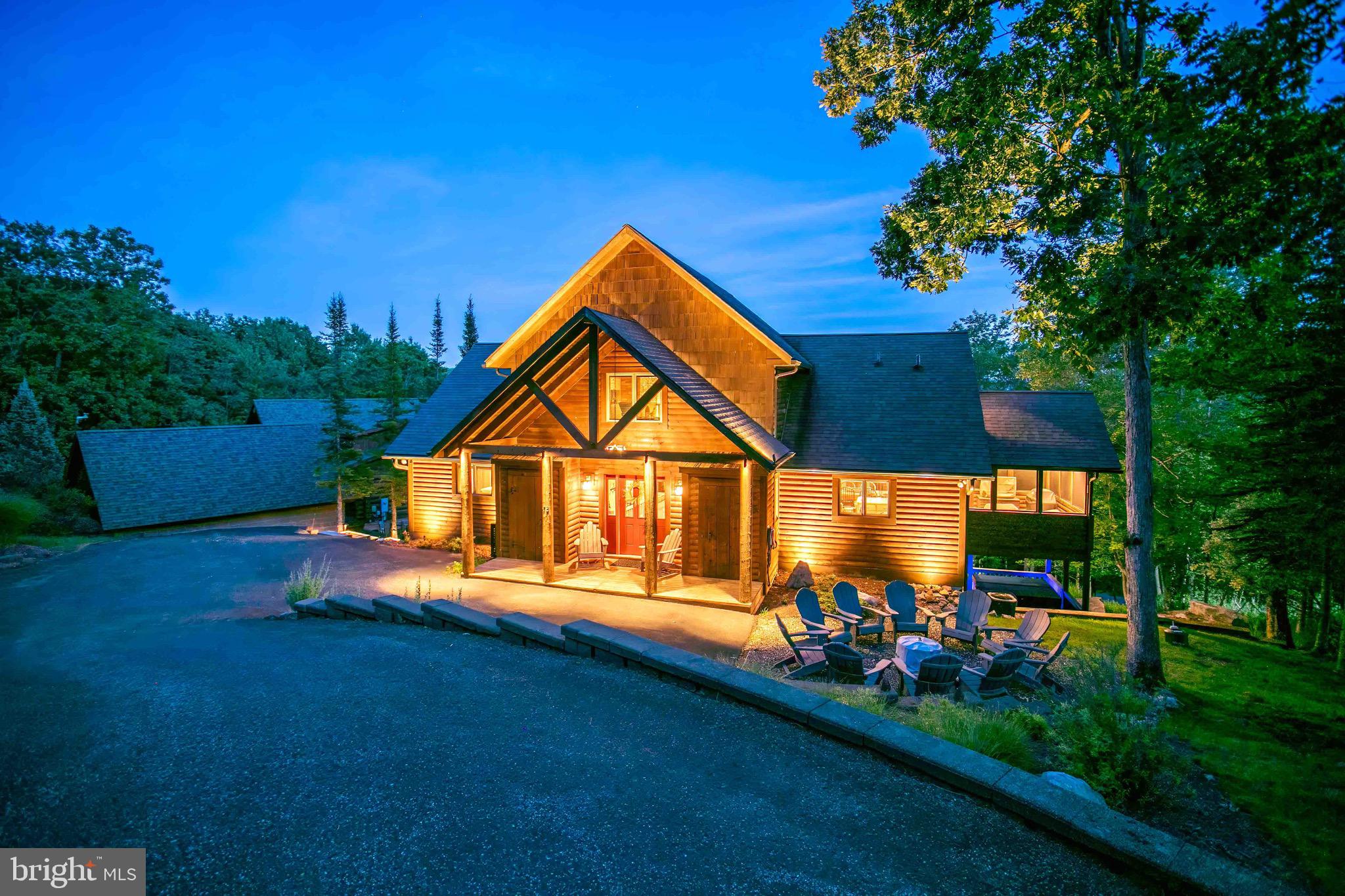 Panoramic lake, mountain, and scenic-vista views define this rustic-elegant Southridge chalet, one of Deep Creek Lake’s most captivating settings in this price range. Positioned on a premium 0.57-acre no-thru-street lot, this 4-bedroom, 4.5-bath retreat spans three fully finished levels and 3,456 square feet, anchored by soaring vaulted wood ceilings, walls of glass, and two stone gas fireplaces.

The open concept main level features a granite and stainless kitchen, hardwood floors, recessed lighting, and a screened sun porch made for morning coffee with a lake view. Three of four bedrooms offer serene lake vistas, two with luxurious en-suite baths featuring jetted soaking tubs. A loft provides a flexible fifth sleeping space for guests, and the walk-out lower level adds a spacious family room centered on a second stone fireplace.

Outside, expansive decks, a hot tub, and a fire-pit area create an outdoor living experience with the lake as your backdrop. Deep Creek Lake access for swimming, fishing, and kayaking is minutes away, as is Wisp Resort for year-round recreation. A paved driveway, EV charger, and HOA maintained roads and snow removal round out the package. Offered fully furnished, simply arrive and enjoy your Deep Creek Lake retreat.