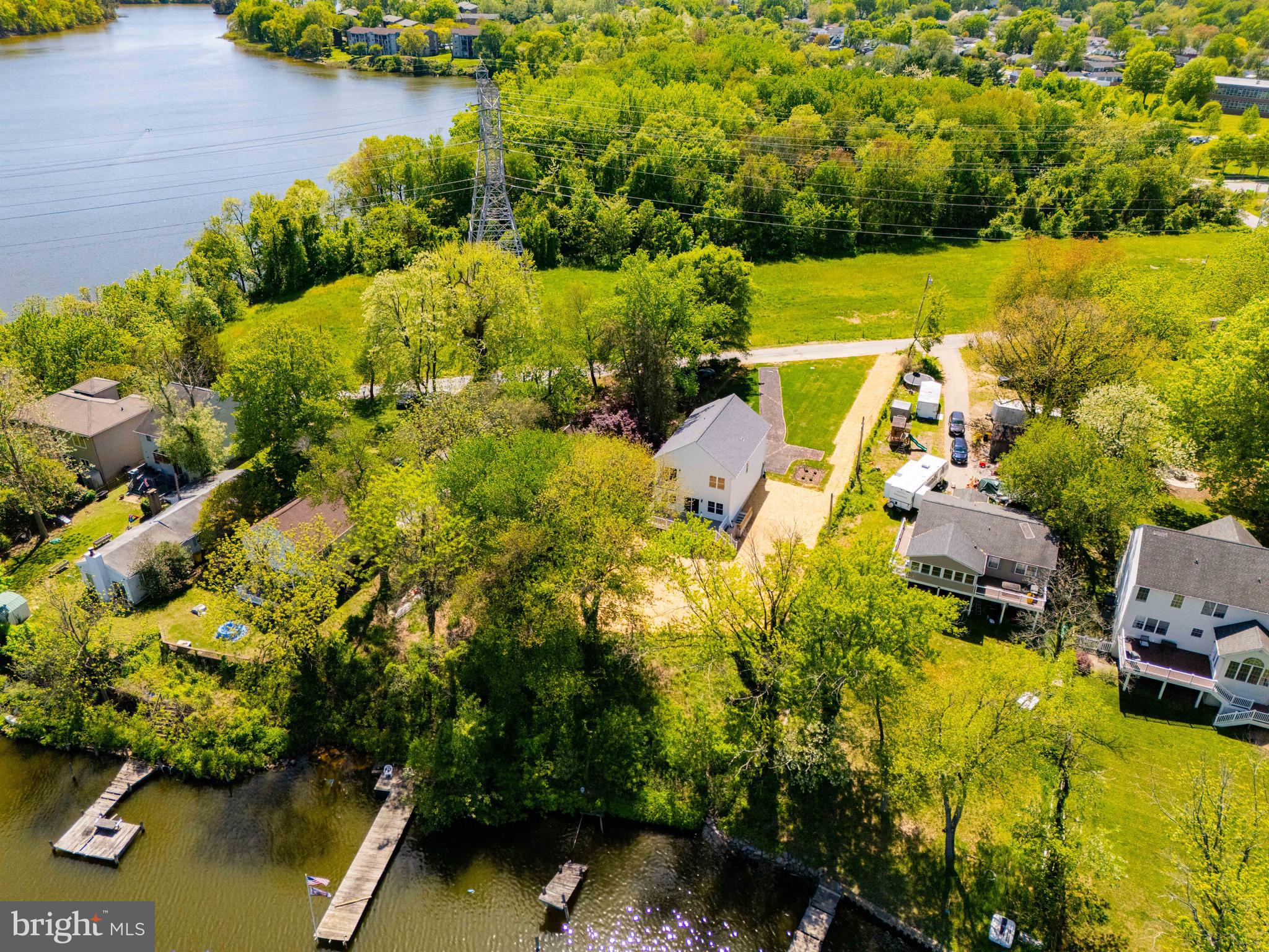 Significant price improvement on this rare opportunity to own a newly built waterfront home on Marley Creek, set on nearly half an acre with wide water views and a level, usable yard. It is difficult to find this combination of newer construction, land, and waterfront lifestyle at this price point.

Natural light fills the main level through expansive rear windows that keep the focus on the water. The layout flows seamlessly from the living area into the kitchen and out to the backyard, creating an ideal setup for both everyday living and entertaining.

Upstairs offers four true bedrooms, including a spacious primary suite with water views. The full-height walkout basement provides excellent flexibility for future living space, recreation, storage, or a home gym and is already roughed in for a future bathroom.

The outdoor setting is what truly sets this property apart. The large yard offers space to expand outdoor living and fully enjoy the waterfront surroundings. As an added bonus, the builder has secured a pier permit that will convey with the property, allowing the next owner to customize their waterfront setup. Estimated water depth at the future pier location is approximately 8 to 10 feet, buyer to verify.

Quietly tucked away while still convenient to major commuter routes, this is a rare chance to own a move-in ready waterfront home with room to grow and make it your own over time.