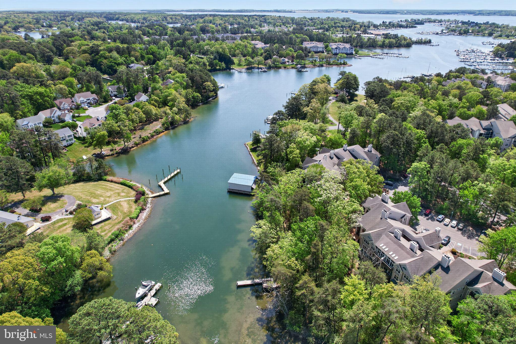 The open design of the Tred Avon floor plan of this top floor end unit  is a stunning Solomons Landing offering creating a waterfront lifestyle facing the Back Creek shoreline that can be enjoyed at your doorstep. A waterside trail surrounds the community where there are piers and kayak racks, as well as a community marina that offers a variety of slip possibilities, providing numerous opportunities to enjoy the water. The living room features Palladian windows with views to the water, beautiful maple flooring, and dramatic ceilings.  Enjoy a fabulous kitchen with extensive cabinetry, expansive granite food prep surfaces, gas cooking, recently replaced stainless appliances, a large pantry, and a breakfast nook - it will be loved by those who appreciate  the culinary experience, the kitchen opening to a large dining area that is a perfect entertainment space.  Relax in the spacious primary suite featuring transom windows creating architectural interest and a bright and welcoming area, with an ensuite bath featuring separate vanities, walk-in shower and soak tub,  The large corner deck can be accessed from the main living area as well as the primary bedroom, providing extended outdoor living. A number of attractive appointments have been added by the sellers making this unit a very special option for full time or second home living.  Waterfront living and resort style amenities await - and yes, there is pickleball, with newly refurbished courts - convenient to charming Solomons where the Chesapeake Bay lifestyle is incomparable.