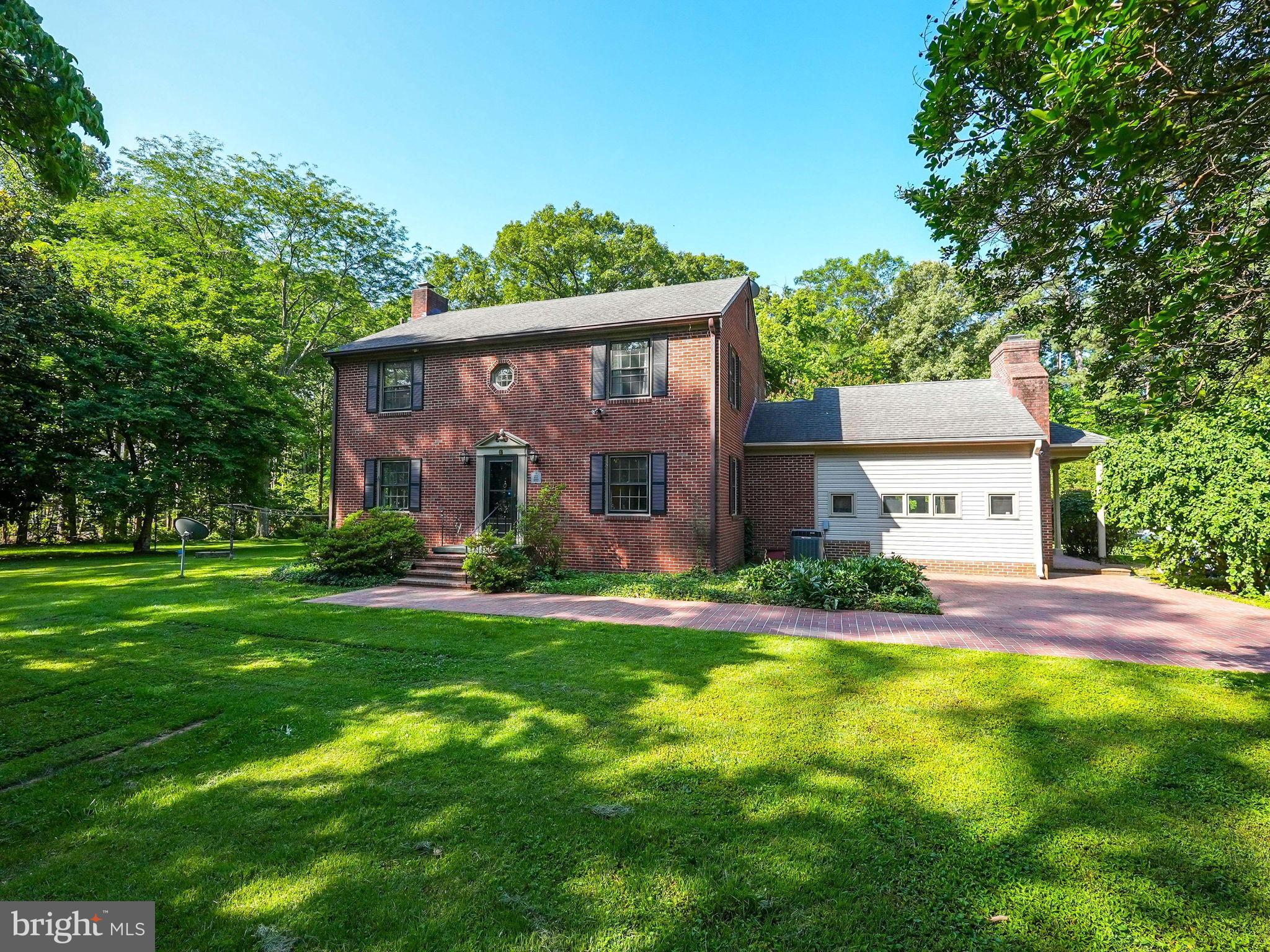 Classic 1959 architecture meets a thoughtfully completed renovation on this all-brick colonial, privately set on 2.5 acres just minutes from Dahlgren and Fredericksburg. Step inside to find a completely reimagined kitchen and dining area — now one bright, open living space featuring crisp white cabinetry, black quartz countertops, and all-new appliances, perfect for everyday living and entertaining alike.
Upstairs, the primary suite offers a true retreat with a spa-like renovated bathroom, complete with an oversized walk-in shower and a double vanity. Fresh paint runs throughout the home, and a newly added main-level laundry room brings everyday convenience to the main floor. A whole-house generator is already in place, offering effortless peace of mind through every season.
Outside, the property's 2.5 private acres are framed by a tree-lined driveway, a circular drive, and a brick wraparound patio — ideal for quiet mornings, outdoor entertaining, or simply enjoying the space and privacy that's increasingly hard to find. Despite the peaceful setting, commuting is easy: Route 301 provides quick access to both Washington, D.C. and Richmond, and the home sits just minutes from NSWC Dahlgren.
An unfinished basement and attic round out the home, offering excellent bonus storage or the opportunity to expand and customize the finished living space to suit your needs. With no HOA and a rare combination of updated finishes, acreage, and location, this home offers exceptional value.