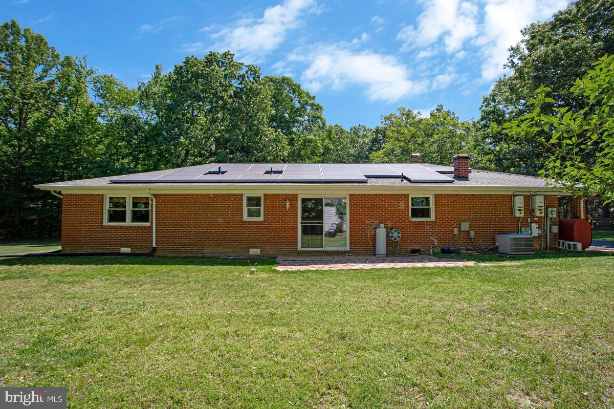 Single level living on 1 acre of flat land! This 3/2 rambler with detached garage and carport may just check all of your boxes! The land is mostly cleared, completely fenced, has FANTASTIC lawn space, is surrounded by trees and is located at the end of the street in a secluded neighborhood. Privacy awaits and with NO HOA, you can garden, entertain outdoors, park your RV, boat or other recreational vehicles and so much more. **NEW** asphalt driveway in 2025! Spare those big electric bills - the solar panels produce nearly 100%l of power consumed. Unwind in the large enclosed front porch in the spring/summer. Sit by the warmth of the fireplace in the living room in the fall/winter, The roof was replaced in 2018. Fireplace insert and chimney liner replaced in 2019. Tankless water heater installed in 2021. For added efficiency and reduced utility costs, insulation in the attic was replaced in 2025 by Orkin and consists of modern pest resistant materials. If you're looking for a house that feels like home, consider this opportunity while you have the chance!