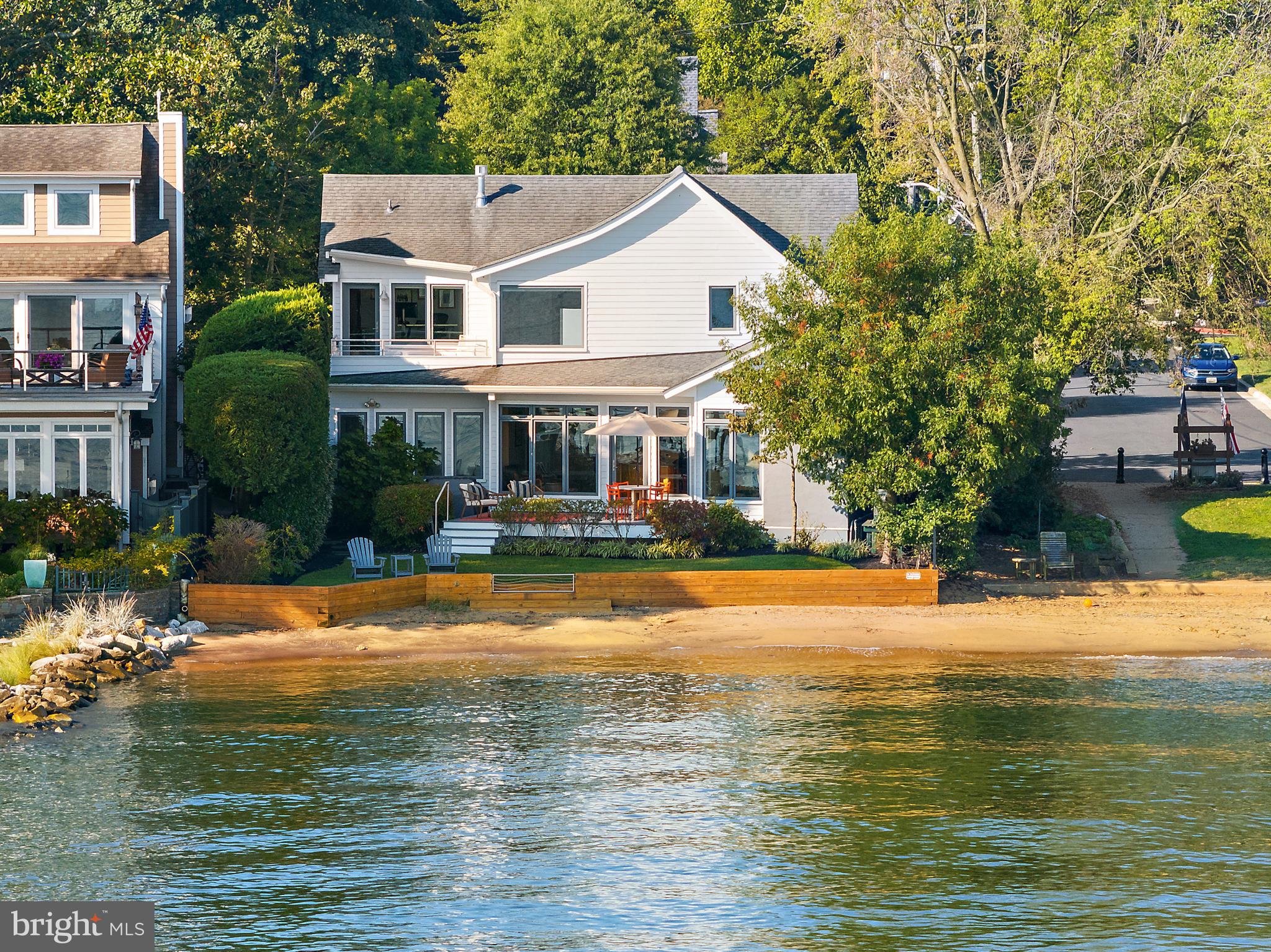 Exceptional Waterfront and Beachfront living on Horn Point in coveted Eastport. Launch your kayak or SUP after morning coffee, and watch the sailboat races from your deck, yard, and beach later that day. This elegant charmer is the Perfect place to watch the Blue Angels without leaving home! The home was completely re-built in 2009 (all that remains is the original garage floor) and has been meticulously maintained.  Upon your first steps inside, you'll be drawn to spectacular views of the Severn River as you walk through an open floor plan adorned with rich Brazilian hardwood flooring and abundant natural light. The main level offers a great room with a perfectly blended family room, dining area with a gas fireplace, a second sitting area, a gourmet kitchen and private deck. A separate hall leads you to 2 spacious bedrooms and full bath. The gourmet kitchen is a chef's dream, featuring upgraded countertops, stainless steel appliances, and a generous island perfect for entertaining. Dining and relaxing on your private deck overlooking the yard and beach is steps away from the kitchen. Privately located behind the kitchen the home gym with vaulted ceilings and water views can be converted to a home office, play area, an additional sitting room, and more.  The main level laundry room and hallway to the garage also lead you to a bonus work-room attached to the garage.  This room could easily become a creative space, painting studio, she-shed, or additional home office.   The beautiful floating staircase complements the great room and leads you to the upper level.  The primary suite is all about the view! Breathtaking Severn River and Chesapeake Bay- front views and a spa-like bathroom with a jetted tub and walk-in, steam shower. The primary suite would not be complete without a large dressing room with access to a separate home office / sitting room with water views, and private deck. The fourth bedroom with en suite is on the upper level, with a walk in closet and access to attic storage. The exterior is equally impressive, showcasing a yard and private beach on the Severn River. Relax on the balcony or deck, surrounded by lush landscaping and exterior lighting that enhances the ambiance. The property also includes an attached garage with attic storage above it and ample driveway space for convenience. A generator is included and a pier is an option for your buyer. With a prime bayside location, this home offers not just a residence but a lifestyle of luxury and tranquility. Experience the perfect blend of modern amenities and natural beauty, making every day feel like a vacation. Don't miss the opportunity to call this remarkable property your own!