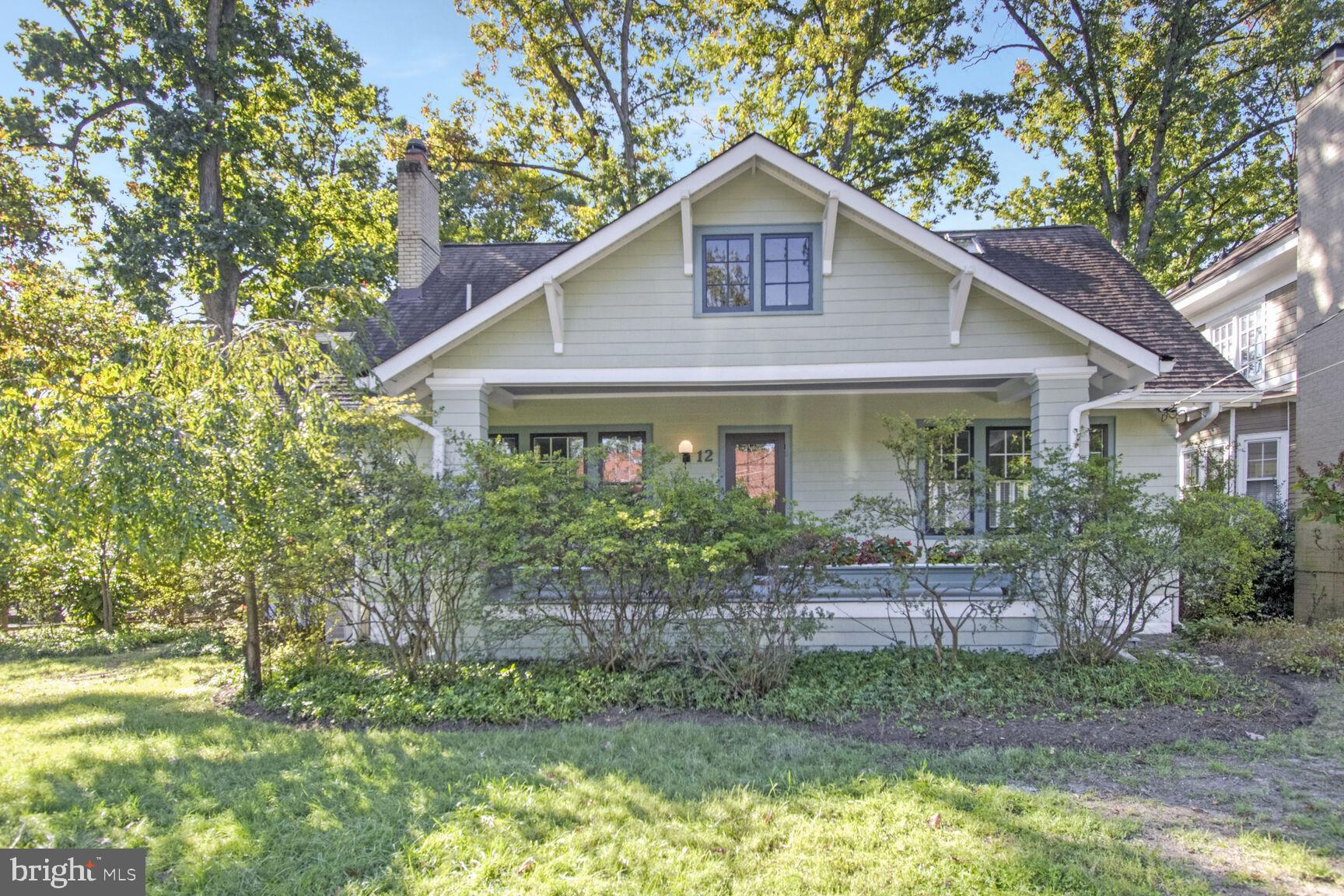 Fabulous expanded and updated 1923 Craftsman bungalow in Historic North Takoma on a quiet cul-de-sac, just 4 blocks to Metro and a few blocks more to Old Town Takoma Park shops, restaurants, and 
farmers  market.  This house combines the best of vintage bungalow charm with modern updates.   On an almost 1/4 acre lot, the house sits near the end of the street on a bluff that overlooks an Eastern panorama. If you are an early riser you will see dramatic sunrises daily.  Check out the photo  I took: what a way to start each day!
Entering from the expansive front porch with custom planter boxes, you will find a very spacious living room with a charming inlay border design in the original refinished oak hardwood floors,  built-in  library shelves, recessed lights, and a wood burning fireplace with reproduction arts & crafts tile.  The dining room features a storage closet for China, a vintage chandelier and arts & crafts windows overlooking the deck.  From the dining room continue to your brand new kitchen!  42" shaker cabinets with soft close drawers, brand new stainless appliances, a very pretty tile backsplash, and a built in double pantry combine with two vintage art deco pendant lights to create a warm and functional space.  
Off the kitchen is an enclosed sunroom with a cozy wood burning stove, views of the rear yard and a glass door to the deck.  Two bedrooms ( one used as an office)  and a vintage black and white full bath complete this side of the house.  Original medicine cabinet and porcelain sconces work well with the stylish floor tile.  The stairway up to the second level is on this side of the house.  Adorable original built in cabinets and drawers in the hallway. 
Heading over to the other side of the house, beyond the dining room, you'll find a very spacious family room with French doors to the deck and steps down to a lower level office.  More built-in shelves line the stairwell, built by the current owner to house his vast antique toaster collection, but would serve just as well for books! 
The upper level is comprised of the owners bedroom and bath in one wing and two bedrooms, bath and sitting area in the other wing separated by a skylit hallway.  The large owner's bedroom features a vaulted ceiling, expansive views of the yard and  his and hers walk-in closets.   Skylights illuminate the stairwell up and the connecting hallway.  The kid's area comprises two nice sized bedrooms and the sitting (play) area.  Ask me about the delightful froggie tiles in the bathroom!
The lower level features a large bright finished flex room with rear outside access: could be kids playroom, family room, or office.  Truly a splendid one-of-a kind house, in an unbeatable location, in the popular North Takoma Historic District.