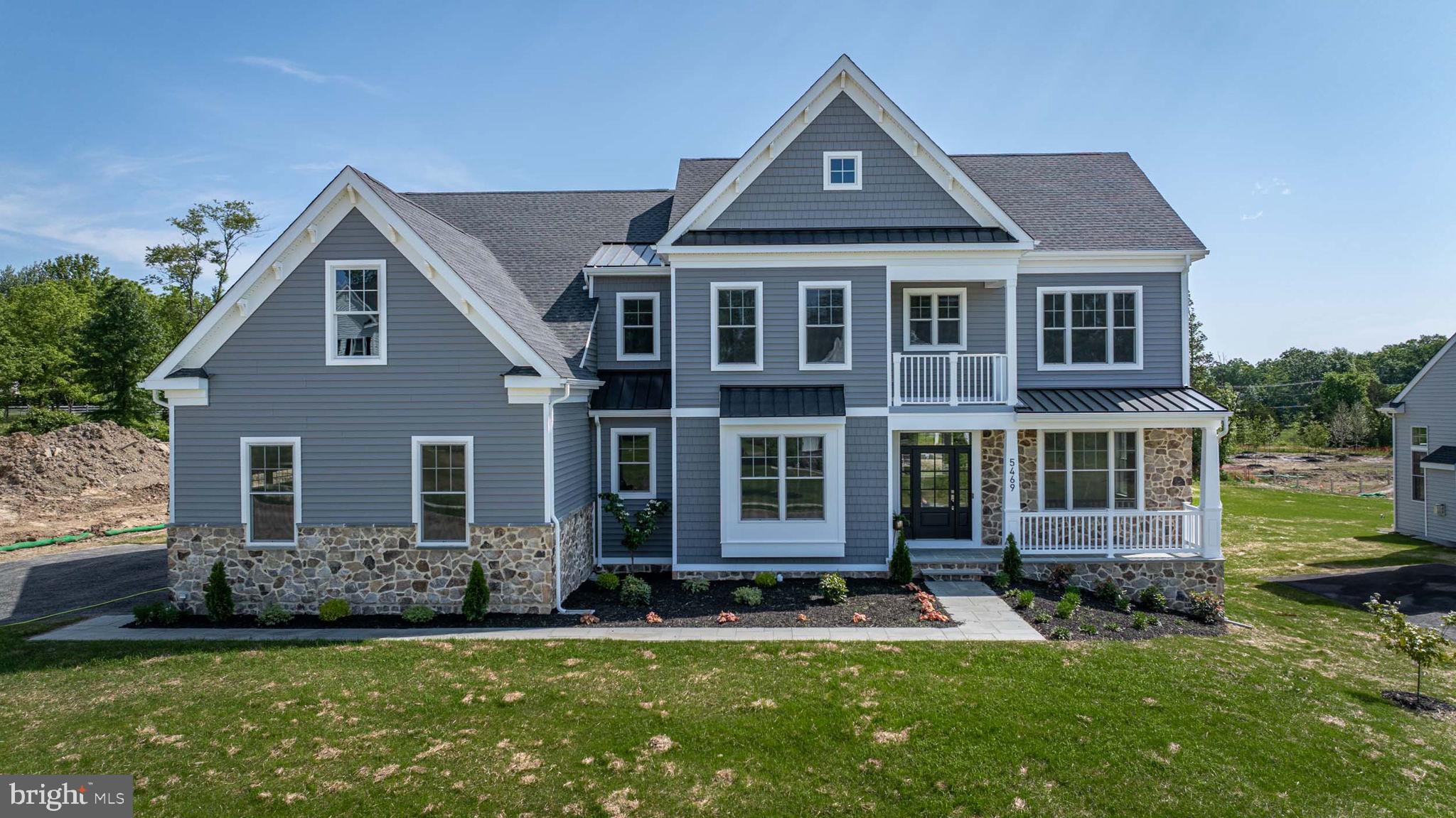 OPEN HOUSE ON SUNDAY, JUNE 2ND HAS BEEN CANCELED. This brand-new, luxurious home features 5 bedrooms, 5 baths, and a 3-car garage. Nestled in the Estates at Holly Ridge within the award-winning Central Bucks School District, this property is part of an exclusive enclave of just 13 homes. Situated in a serene cul-de-sac setting, the home offers picturesque rural views of Bucks County. The curb appeal is immediately evident with a Bluestone lead walk and covered front porch, complemented by professional landscaping. As you step inside, you are greeted by wide plank hardwood flooring and a tray ceiling in the foyer. To your right is a versatile flex room with French glass doors, perfect for a home office, den, or living room. On the left, you'll find an elegant dining room. The heart of the home is the Great Room, featuring a gas fireplace, abundant natural light from windows all around, and sliding doors leading to the backyard. The opulent kitchen is a culinary delight with quartz countertops, farm sink, large center island, and top-of-the-line appliances including a Sub-Zero refrigerator, Wolf wall oven and microwave, a Wolf 6-burner stove with exposed stainless steel hood vent, and an Akso dishwasher. Custom backsplash and ample cabinetry provide the perfect space for entertainment. You’ll love the bonus butler’s pantry with wet bar too and beverage center. The in-law suite or first-floor bedroom includes a full bathroom with quartz counters, a large shower stall with frameless glass, and tile throughout. Ascending the stairs, you'll notice upgraded oak treads and metal balusters. The second level hallway continues the hardwood flooring. The primary suite, accessed through French doors, offers stunning backyard views and a functional sitting area. The spa-like primary bathroom features dual vanities with quartz counters, a free-standing soaking tub, an oversized shower stall with frameless glass, ceramic tile, and a private water closet. The spacious walk-in closet comes with custom organizers. Each of the three additional upstairs bedrooms is an en-suite with walk-in closets and upgraded bathrooms. The front bedroom has access to a covered balcony with fabulous views. A convenient laundry room with cabinetry, a sink and granite counters provides plenty of room. The finished lower level is versatile, perfect for a secondary family room, gym, home office, or a space to watch the big game. It includes luxury vinyl plank flooring, a kitchenette area with a sink, KitchenAid beverage fridge, custom cabinetry, backsplash, and sliding doors with double wide walk-up steps to the outdoors. There's also an additional bedroom and full bathroom, echoing the upgrades found throughout the home. Unfinished areas provide for plenty of storage. This home boasts 9-foot ceilings on all levels, a whole-home generator, custom closet organizers, and a Guardian security system with Smart Home Technology. Estates at Holly Ridge is just minutes from downtown Doylestown, offering a variety of shopping, restaurants, and museums. For outdoor enthusiasts, Peace Valley Park & Lake Galena are close by. Schedule a showing today and discover why 5469 Sanderling Drive is the perfect place to call home.