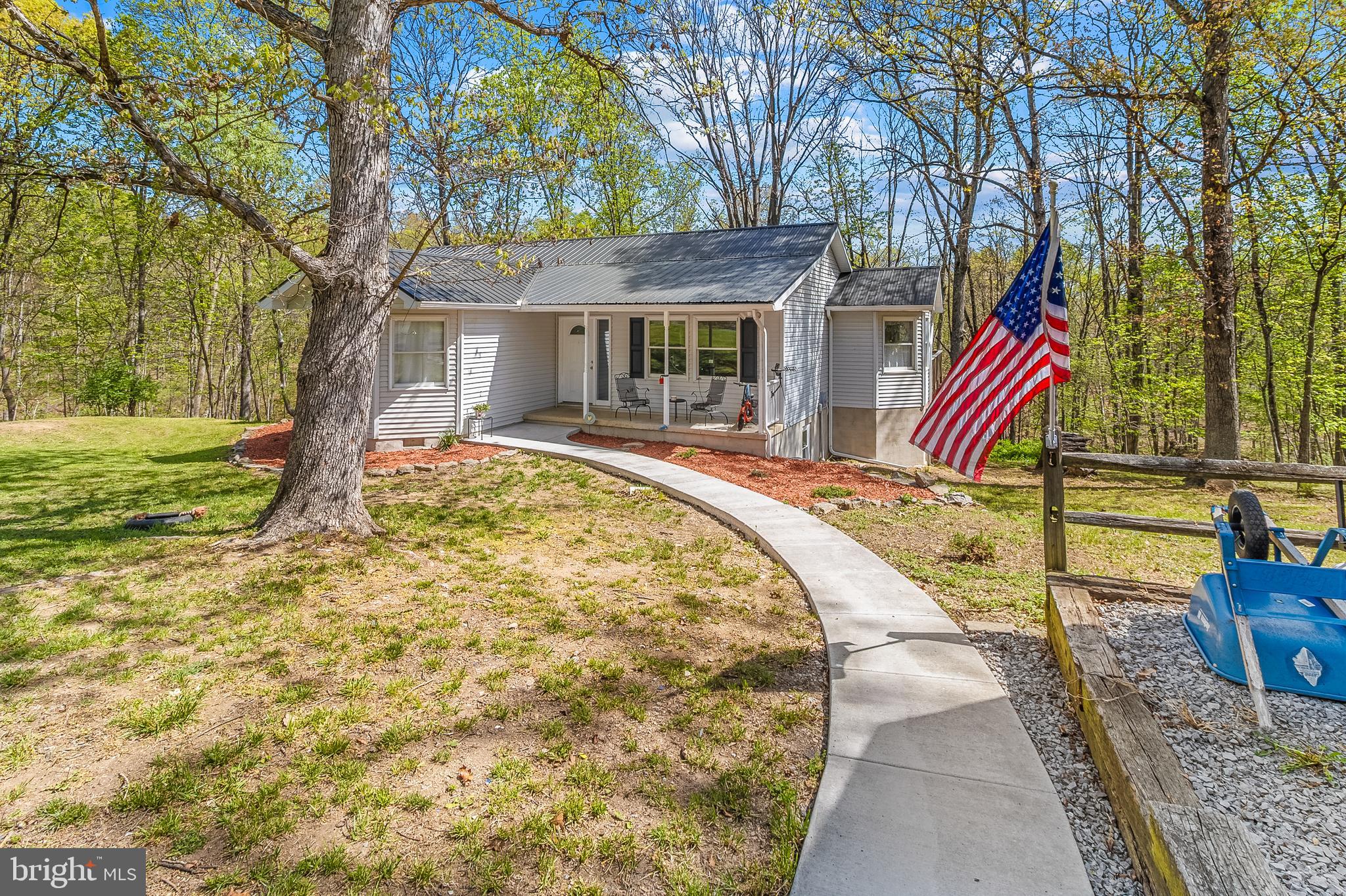 SELLER OFFERING $5,000 IN CONCESSIONS!  
Welcome to this beautifully updated ranch-style home set on 4.66 wooded acres, offering exceptional privacy, open space, and a peaceful natural setting. With over 2,600 sq. ft. of living space, this 5-bedroom, 3-bath residence provides plenty of room to spread out while enjoying the quiet of a low‑traffic road with only a handful of nearby homes.
The property includes 2 flat acres in the back, featuring mature white and red oak—ideal for outdoor recreation or future use. It’s a prime bow‑hunting location and a paradise for bird watchers and wildlife enthusiasts, with clean, crisp air and abundant natural beauty.
This is a rare opportunity to own a spacious, updated home surrounded by nature. Come see everything this incredible property has to offer!

Inside, the home has been extensively updated in 2022, giving it a fresh, modern feel throughout. Improvements include a new roof, updated flooring, lighting fixtures, fresh interior paint, and a finished basement. The kitchen has been thoughtfully renovated with new cabinetry, granite countertops, and updated appliances, creating a bright and functional space for cooking and gathering. A new HVAC system adds efficiency and comfort year-round. The main level also features a convenient laundry area for everyday ease.

The finished lower level expands the living possibilities with additional space that could serve a variety of needs. With its own full bathroom and a second laundry area already in place, it offers flexibility for extended household arrangements, recreation space, a home office, or guest accommodations.

Outdoor living is just as appealing. Step out onto the rear deck and enjoy the quiet setting surrounded by mature trees and natural scenery. The nearly five-acre property provides space to explore, garden, or simply enjoy the outdoors while still being conveniently located near major highways for commuting and travel.

Located near the City of Martinsburg, this property offers access to a growing and vibrant community in the Eastern Panhandle of West Virginia. Martinsburg is known as the Gateway to the Shenandoah Valley and serves as the county seat of Berkeley County, one of the fastest-growing areas in the state. Residents enjoy a blend of historic charm, expanding amenities, and proximity to outdoor recreation, shopping, dining, and regional travel routes.

This property combines the comfort of modern updates with the tranquility of a wooded setting, creating a unique opportunity to enjoy both privacy and convenience. Schedule your visit and experience everything this home and its surroundings have to offer.