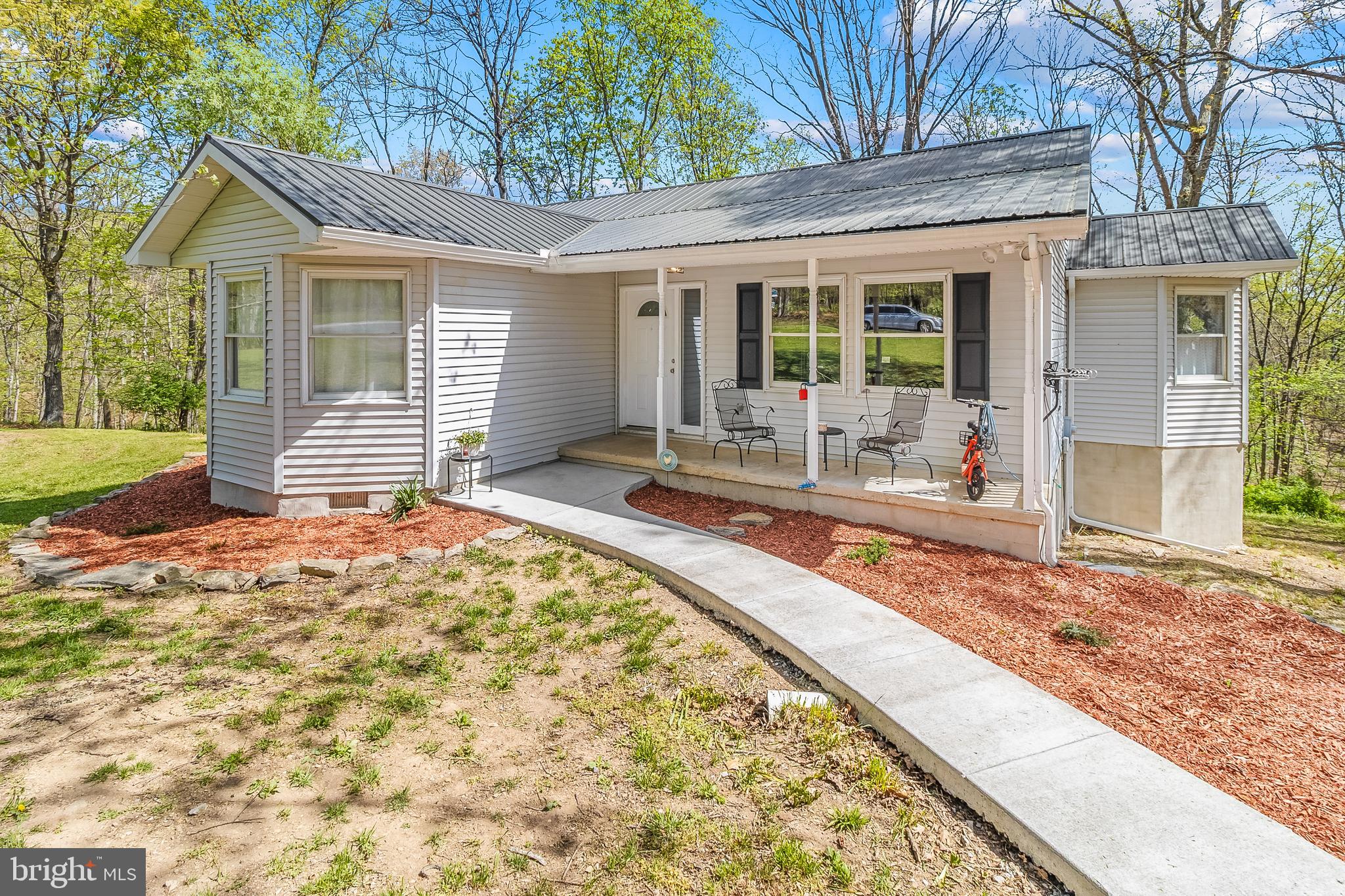 **SELLER OFFERING $5K CONCESSIONS*** Welcome to a beautifully updated ranch-style home set on 4.66 wooded acres, offering privacy, space, and a peaceful natural setting. With over 2,600 square feet of living space, this 5-bedroom, 3-bath residence provides room to spread out while enjoying the calm surroundings of a quiet road with only a few nearby homes.

Inside, the home has been extensively updated in 2022, giving it a fresh, modern feel throughout. Improvements include a new roof, updated flooring, lighting fixtures, fresh interior paint, and a finished basement. The kitchen has been thoughtfully renovated with new cabinetry, granite countertops, and updated appliances, creating a bright and functional space for cooking and gathering. A new HVAC system adds efficiency and comfort year-round. The main level also features a convenient laundry area for everyday ease.

The finished lower level expands the living possibilities with additional space that could serve a variety of needs. With its own full bathroom and a second laundry area already in place, it offers flexibility for extended household arrangements, recreation space, a home office, or guest accommodations.

Outdoor living is just as appealing. Step out onto the rear deck and enjoy the quiet setting surrounded by mature trees and natural scenery. The nearly five-acre property provides space to explore, garden, or simply enjoy the outdoors while still being conveniently located near major highways for commuting and travel.

Located near the City of Martinsburg, this property offers access to a growing and vibrant community in the Eastern Panhandle of West Virginia. Martinsburg is known as the Gateway to the Shenandoah Valley and serves as the county seat of Berkeley County, one of the fastest-growing areas in the state. Residents enjoy a blend of historic charm, expanding amenities, and proximity to outdoor recreation, shopping, dining, and regional travel routes.

This property combines the comfort of modern updates with the tranquility of a wooded setting, creating a unique opportunity to enjoy both privacy and convenience. Schedule your visit and experience everything this home and its surroundings have to offer.