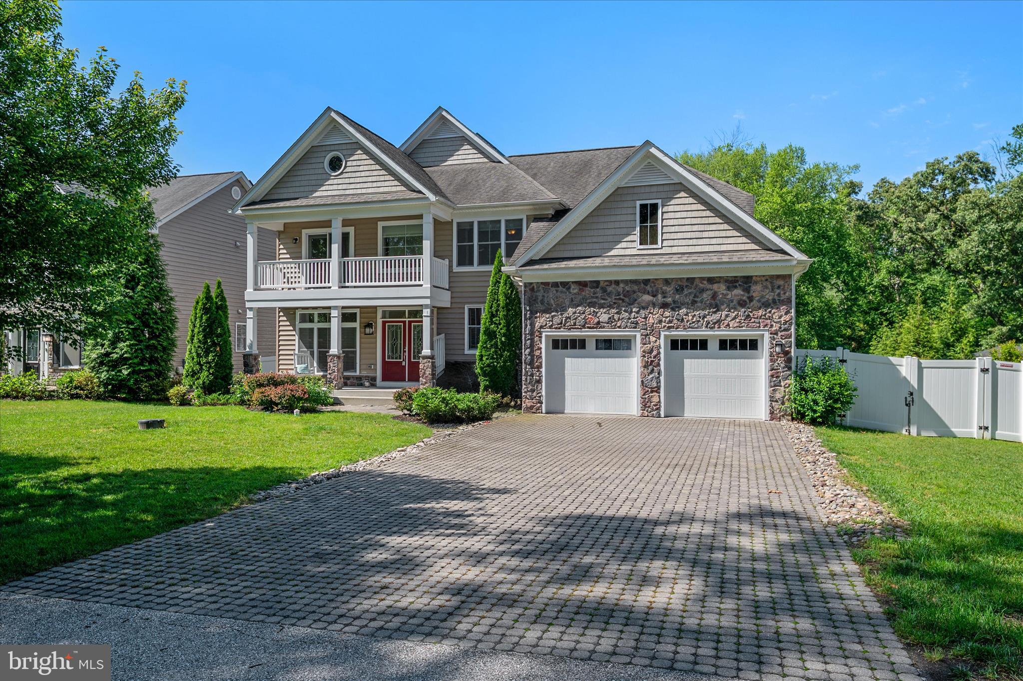 This extensively customized 5 bed, 5 1/2 bath home offers the ideal blend of style, convenience, and privacy. The property is situated on a cul-de-sac street and backs to protected woodlands, with a fenced-in back yard and heated saltwater pool. Enter the house to find an expansive kitchen outfitted with top-of-the-line KitchenAid appliances and a huge island for entertaining. Enjoy a meal in the separate dining room or grill out on the deck after a swim, then retire upstairs to the spacious primary suite, which boasts dual walk-in closets and luxury bath. Additionally, there are three full en suites on the bedroom level for guests to choose from. Adding to the convenience are the dual-load washer and dryer located just down the hall. Stop in to the private main-level study to wrap up a work day, unwind in the great room by the fireplace, or head straight down to the fully finished basement, where there's an additional bedroom, full bath, game room, outdoor access, wet bar and exercise room. Providing alternative/supplemental power is a fully-owned, 58 panel solar array that feeds into two Tesla Powerwalls with Solar Edge inverter and an energy efficient smart system. With a two-car garage, .35 acres to enjoy, and just a few minutes walk to the B & A Trail, this property is the whole package. Guard Home Warranty included!