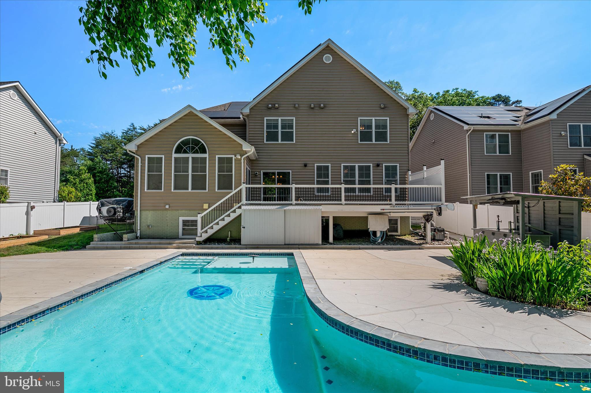 This extensively customized 5 bed, 5 1/2 bath home offers the ideal blend of style, convenience, and privacy. The property is situated on a cul-de-sac street and backs to protected woodlands, with a fenced-in back yard and heated saltwater pool. Enter the house to find an expansive kitchen outfitted with top-of-the-line KitchenAid appliances and a huge island for entertaining. Enjoy a meal in the separate dining room or grill out on the deck after a swim, then retire upstairs to the spacious primary suite, which boasts dual walk-in closets and luxury bath. Additionally, there are three full en suites on the bedroom level for guests to choose from. Adding to the convenience are the dual-load washer and dryer located just down the hall. Stop in to the private main-level study to wrap up a work day, unwind in the great room by the fireplace, or head straight down to the fully finished basement, where there's an additional bedroom, full bath, game room, outdoor access, wet bar and exercise room. Providing alternative/supplemental power is a fully-owned, 58 panel solar array that feeds into two Tesla Powerwalls with Solar Edge inverter and an energy efficient smart system. With a two-car garage, .35 acres to enjoy, and just a few minutes walk to the B & A Trail, this property is the whole package. Guard Home Warranty included!