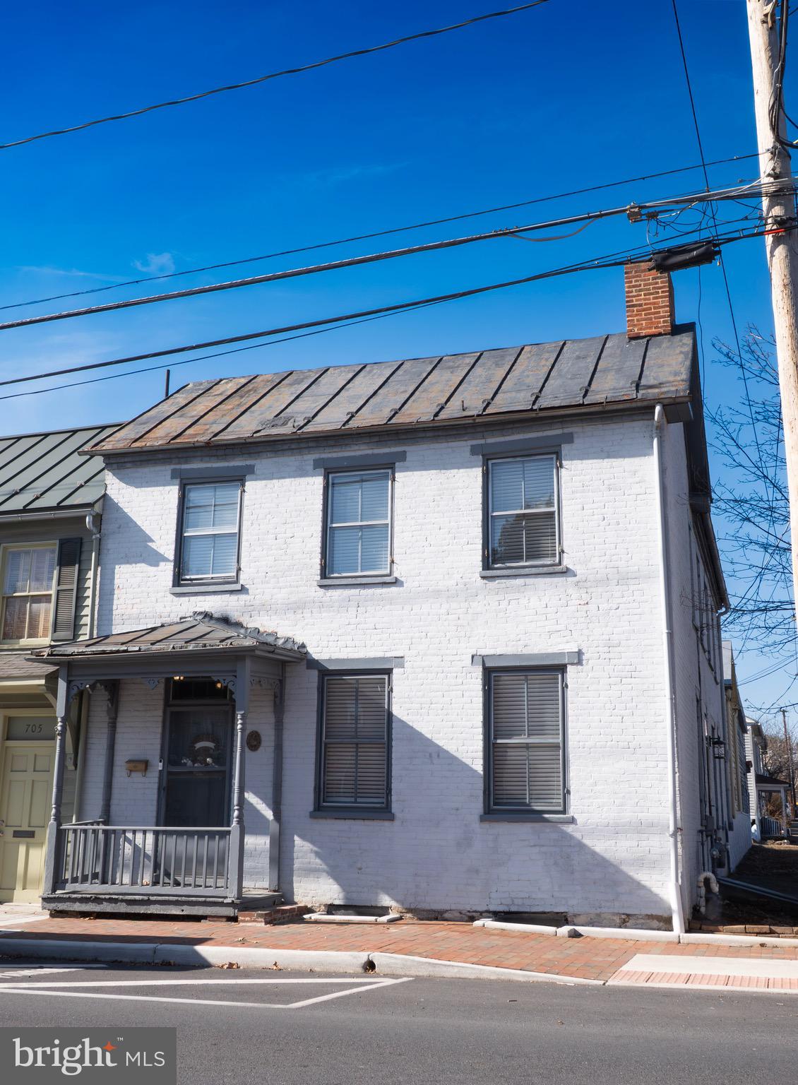 Located in the heart of Winchester’s Historic District, this remarkable property offers a rare opportunity to own a piece of the city’s rich architectural heritage just moments from vibrant Old Town Winchester. Blending timeless character with flexible living options, the home showcases classic historic charm paired with thoughtful updates that support today’s lifestyle.

Inside the main residence, you’ll find warm hardwood flooring, detailed millwork, built-in features, and inviting fireplaces that highlight the home’s original craftsmanship. Spacious living and dining areas provide an ideal setting for both everyday living and entertaining. The layout offers functional flow, with well-proportioned rooms and abundant natural light throughout.

Upstairs, generously sized bedrooms provide comfortable retreats, including a primary suite with its own private bath. Additional bedrooms and a second full bath ensure convenience and flexibility for guests or family. On the main level, a versatile bonus space offers options for a home office, reading nook, or mudroom, along with practical features such as laundry and a powder room.

Adding to the property’s appeal is a separate secondary structure with its own address, offering valuable additional finished space ideal for guests, studio use, or potential income-producing opportunities. Behind it, multiple outbuildings provide exceptional storage, workshop potential, or future redevelopment possibilities.

Outdoor amenities include off-street parking and a generous rear yard setting that enhances both privacy and usability. The property’s zoning allows for a variety of residential and potential mixed-use opportunities, offering flexibility rarely found in a historic setting.

With its unbeatable location, architectural charm, and multi-structure versatility, this unique offering presents endless possibilities for homeowners, investors, or those seeking a distinctive property in one of Winchester’s most desirable historic neighborhoods.