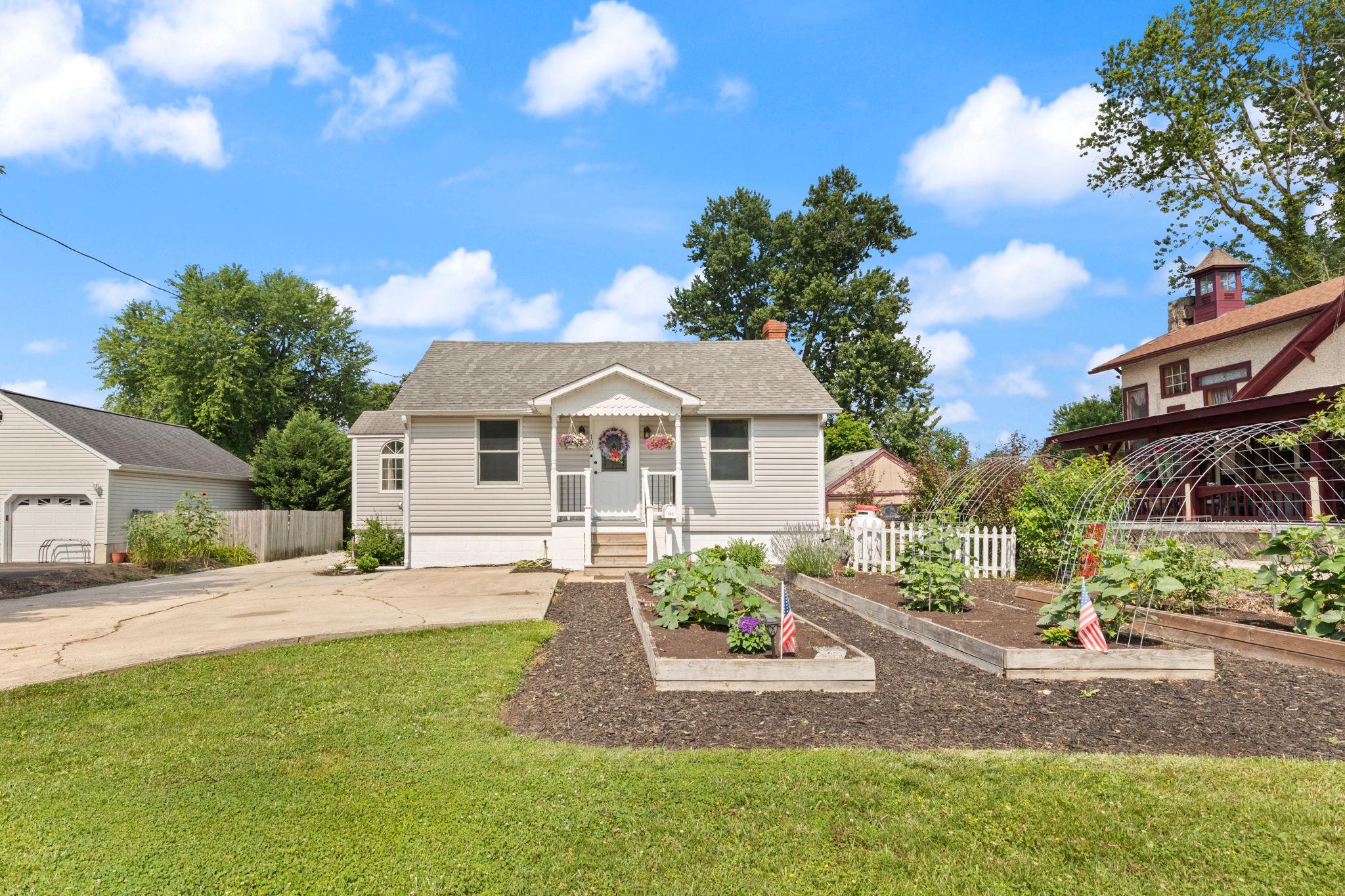 Nestled in a serene setting, this charming 1946 bungalow exudes warmth and character, offering a perfect blend of classic design and modern comforts. With 1,716 square feet of thoughtfully designed living space, this home invites you to experience a lifestyle of ease and tranquility. Step inside to discover a cozy, but open, interior that features beautiful wood floors and an inviting combination dining and living area, perfect for gatherings or quiet evenings at home. The country-style kitchen is a delightful space, equipped with essential appliances including an electric oven/range, microwave, and dryer, ensuring that culinary adventures are both enjoyable and convenient. The attic provides additional storage or potential for creative expansion, while the full basement, accessible via a connecting stairway, offers endless possibilities for customization. The home boasts three spacious bedrooms, each designed to provide a restful retreat. The full bathroom is well-appointed, ensuring comfort for all. Natural light pours in through double-pane windows, enhancing the home's inviting atmosphere. Outside, the property is equally impressive. Set on a generous 0.24-acre lot, the level yard features a beautifully maintained front yard and a rear yard that beckons for outdoor enjoyment. The exterior is adorned with thoughtful features such as exterior lighting, sidewalks, and street lights, enhancing both safety and aesthetics. A charming pavilion invites you to unwind while enjoying views of the lush garden and surrounding trees, creating a peaceful oasis right at your doorstep. Parking is a breeze with a detached garage and a paved driveway that accommodates multiple vehicles. The property also includes a unique poultry house, adding a touch of rustic charm and potential for hobby farming or creative use. This home is not just a residence; it's a lifestyle. Enjoy the tranquility of suburban living while being conveniently located near local amenities. Whether you're hosting friends on the patio or enjoying a quiet evening surrounded by nature, this bungalow offers a perfect backdrop for creating cherished memories. Experience the comfort and charm of this delightful property, where every detail has been designed with care and warmth.
