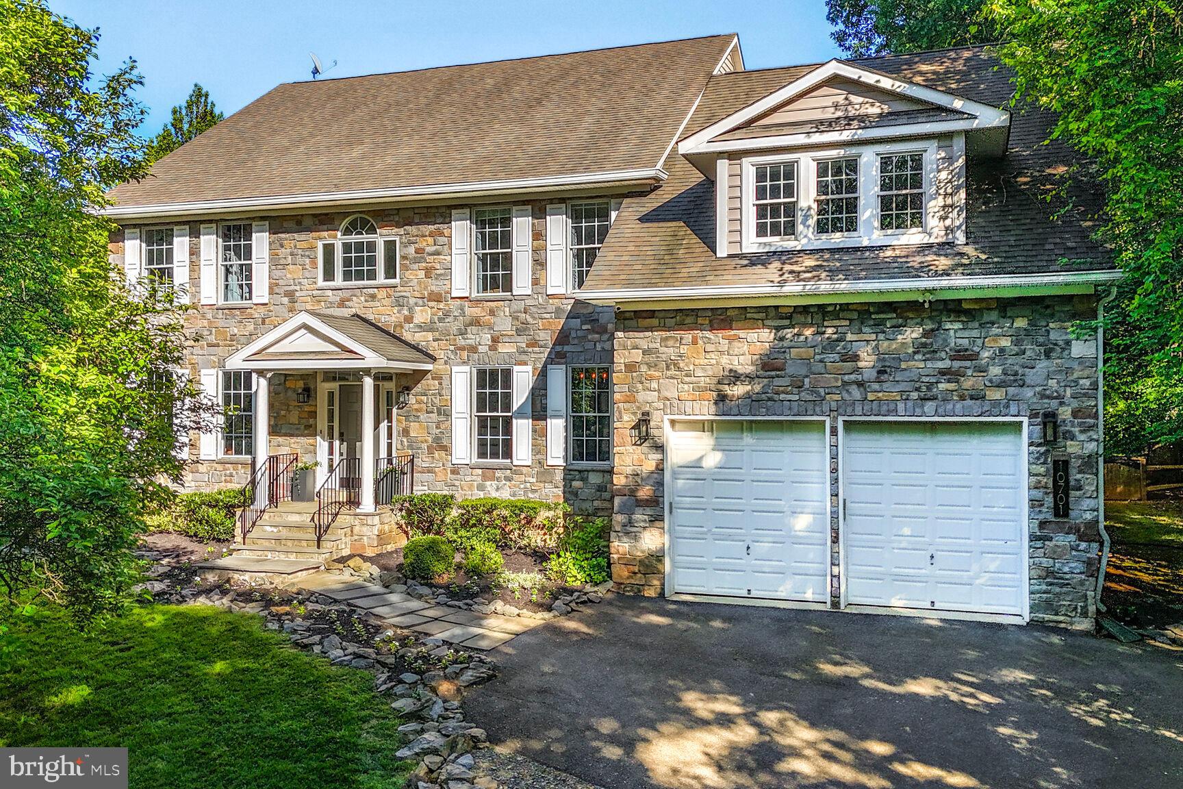 Welcome to 10701 Hunting Lane in Rockville.  One of three stunning stone front, custom residences nestled among half acre+ homesites in the Wootton school district.
Featuring 4 spacious bedrooms, 2 bonus rooms, 4.5 luxurious bathrooms, a dedicated home office, a stylish mudroom and laundry room for added convenience, and expansive living areas.  This home has undergone exquisite renovations and is poised to redefine luxury living.   The beautifully situated homesite is surrounded by serene landscaped grounds, lined with mature trees creating a private retreat for relaxation and/or play; The front and back yards are perfect for both entertaining and/or quiet living.   Upon arrival, enter into a 2 story welcoming foyer with a wrought iron double sided staircase, formal living and formal dining rooms, a custom-designed office with built-ins, and a roomy half bathroom.  Take pleasure in the captivating gourmet kitchen, a haven for an aspiring chef & an entertainers dream.  Featuring the finest in custom cabinetry & sleek countertops (Soapstone), a grand island, top of the line appliances including a 6 burner gas stove, 2 ovens, a built in microwave, and extra beverage and wine refrigerators.  The flow is seamless right into the generous sized family room featuring 10 ft ceilings & oversized windows, filling the home with an abundance of natural light.  A floor to ceiling Stone gas fireplace adds character and sophistication.   The delightful screened in porch allows for year round outdoor living with 2 built in heat lamps, adding even more warmth and charm to a perfect place for family gatherings and/or quiet nights in; Truly an outdoor oasis of your own awaits with a fire pit overlooking a lush, picturesque yard.   The entire home is enhanced by meticulous detail, gleaming hardwood floors throughout (minus the upstairs bedrooms) to elegant and modern light fixtures, high-end craftsmanship on every level.  Upstairs, the expansive owner's suite serves as a private retreat, complete with a spacious sitting room and  a 2 sided gas fireplace, 2 capacious & custom built walk-in closets and a spa-like en-suite bathroom. Prepare to be amazed by the luxurious bathroom featuring modern tile accents, an oversized walk-in glass-door shower, 2 sinks/vanities, a soaking tub and a separate make up vanity.  The upper level also includes 3 unusually large additional bedrooms, all with vast walk-in closets with custom built in shelving and drawers, and two well-appointed full bathrooms (one shared).  The fully finished lower level provides 2000+ more square feet of versatile living space. Whether you're hosting movie nights, enjoying games, or working out, this space is a perfect mix of function and flexibility. It includes 2 oversized Recreational Rooms, one of them being perfect for a personal dance studio, playroom or gym. This level also features 2 additional Bonus rooms and a full bathroom in between the two, providing ample space for guests, extended family, or multi-generational living.   Situated in a prime location, this home offers convenient access to major commuter routes, parks, recreational amenities, and prestigious golf courses. It is also within reach of top-rated Montgomery County schools.   Don’t miss your chance to own this extraordinary home.  A must-see,  this 7000 square feet of meticulously crafted living space, showcases the finest finishes throughout an exceptional floor plan.