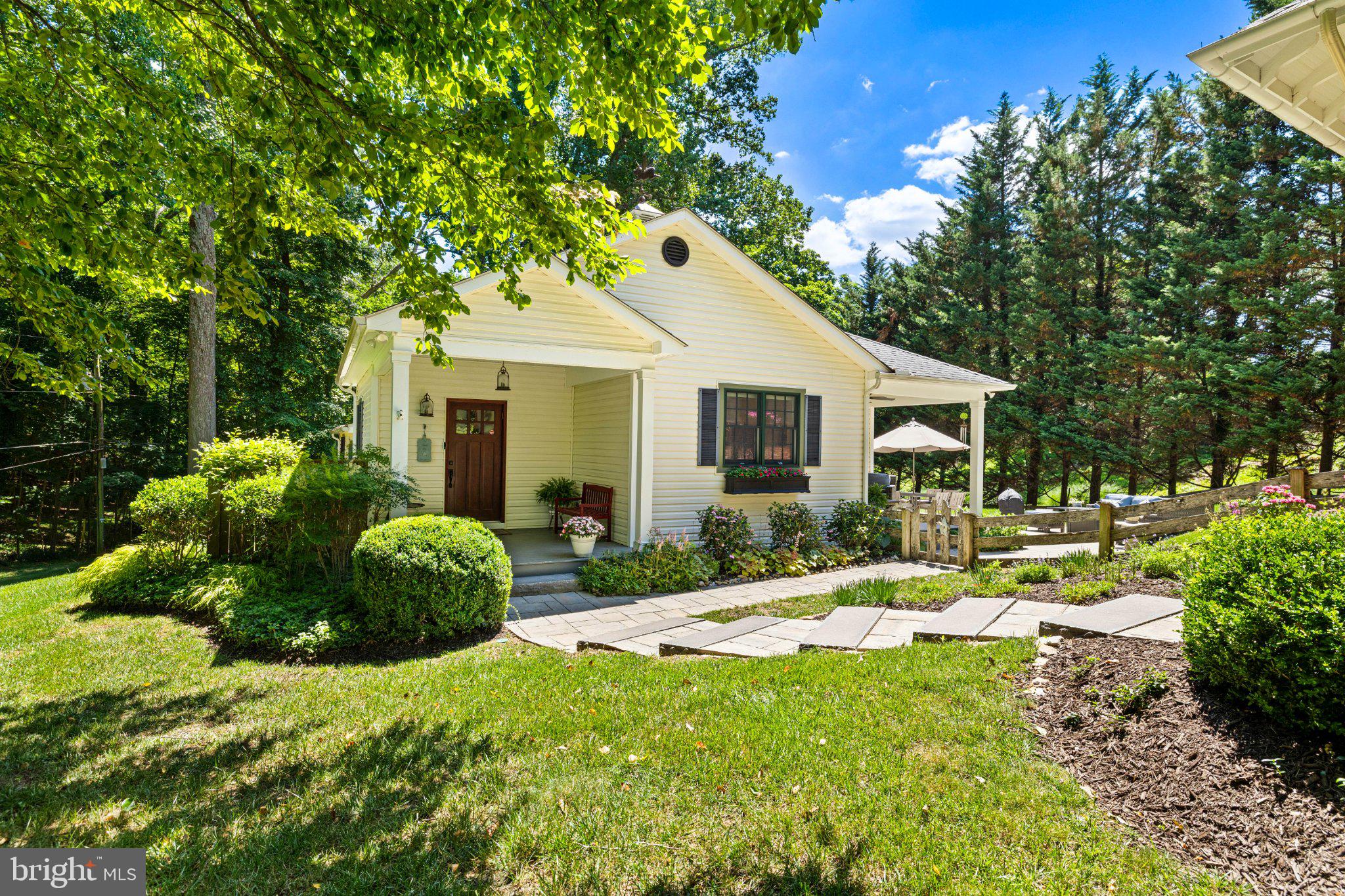 Located in the heart of prestigious Greenspring Valley on 1+ acre of beautifully landscaped, wooded grounds within an intimate private gated community, this exceptional vintage farmhouse offers a rare combination of timeless charm, modern comfort and an extraordinary natural setting.  Originally rich in character and thoughtfully expanded in 2014, this home offers approximately 2250 square feet of beautifully finished living space. Warm hardwood floors throughout complemented by board and batten detailing, and a 2 sided fireplace reflect the home's classic Farmhouse heritage.  Outdoor living is this gem's shining glory.  A charming screened front porch, with 2 additional covered porches, invite you to relax and enjoy the beauty of every season. An expansive patio, professionally designed gardens and multiple outdoor entertaining areas create an exceptional setting for intimate evenings or larger gatherings. This one of a kind property offers the warmth and character of a historic farmhouse with the updates today's buyers desire. Homes with this combination of architectural charm, natural beauty and exceptional outdoor living seldom become available.