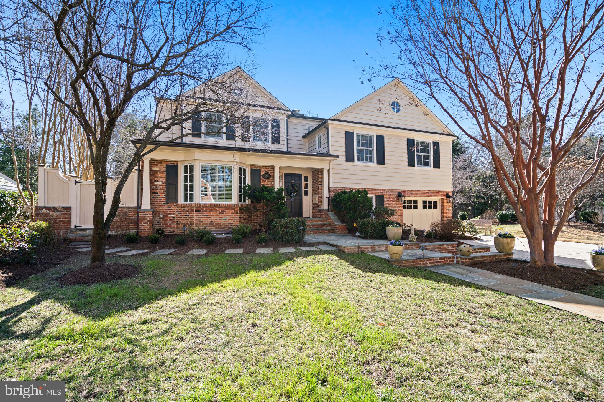 OFFER DEADLINE TUE MAR 17 at 4:00 p.m. Welcome to 5310 Elliott Road, a meticulously maintained and beautifully expanded home adjacent to Westmoreland Park in the sought-after Westmoreland Hills neighborhood of Bethesda. Just blocks from Spring Valley (DC), this spectacular residence is not trying to be the standard Colonial on the block. And that is exactly the point. The design choices are made for real life, prioritizing scale, livability, and thoughtful spaces. The quality and level of investment radiate from the gleaming hardwood floors, custom millwork and trim, and decorative moldings to the custom tile work, built-ins, and manicured grounds.

Encompassing approximately 4,500 square feet across four finished levels with five bedrooms, three full baths, and two half baths, the home offers a proven floor plan with exceptional flow. Its stately façade, flagstone walkway leading to a covered front entry, and professional landscaping with an inground sprinkler system, upgraded exterior lighting, and extensive hardscaping create striking curb appeal.

Inside, a formal foyer with crown molding sets the tone. The renovated kitchen anchors the home with furniture-quality inset cabinetry, quartz countertops, and current lighting. The center island invites gathering while the breakfast nook offers a relaxed place to start the day. Designed for entertaining, the kitchen features state-of-the-art appliances including a Wolf range, second wall oven, warming drawer, and even an extra single-drawer dishwasher. Just off the kitchen is a Georgetown-inspired morning patio enclosed by a masonry privacy wall and framed custom fence, creating a peaceful and private place to sip coffee while still open to the day.

The formal dining room enjoys a large bay window that fills the room with natural light and connects seamlessly to a cozy library with built-ins and a gas fireplace. A powder room is conveniently tucked nearby.

The sun-filled living room is anchored by another fireplace and flows into the gracious family room, which features custom built-ins, an additional fireplace, a bar area, tray ceilings, heated wood floors, and sliding glass doors opening to the wrap-around stone patio overlooking the verdant fenced backyard.

A main-level bedroom or den with en suite bath offers flexibility for guests or a home office. The attached on-grade one-car garage and private level driveway provide off-street parking and play space, and a side entry was thoughtfully positioned to take advantage of the park just steps away.

The second level offers three bright bedrooms with custom closets and wood floors, a newly renovated bath, attic access for storage, and a large laundry room.

The third level is dedicated to the expansive primary suite spanning more than 525 square feet. The suite includes an oversized bedroom, private covered balcony with treetop views, a sitting area with custom bookcases, fireplace with granite surround, a walk-in closet with center island storage and boutique-style built-ins, and a windowed full bath with dual-sink vanity, recessed linen cupboard, separate soaking tub, and oversized shower.

The lower level includes a recreation room, exercise room, full bath, large walk-in pantry, wine cellar, and workshop or storage space. An egress window allows for the possibility of creating a future legal bedroom.

Additional features include three HVAC systems, an insulated and floored attic with temperature control, built-in speakers throughout the home, and a hardwired security and fire alarm system.

The impeccable landscaping surrounds the home with mature trees and lush greenery, creating privacy and tranquility. Wide patios provide space for roasting marshmallows or hosting gatherings of up to 125 guests for a backyard wedding. Exterior improvements include copper gutters throughout the home, a new roof in 2025, and replacement windows.