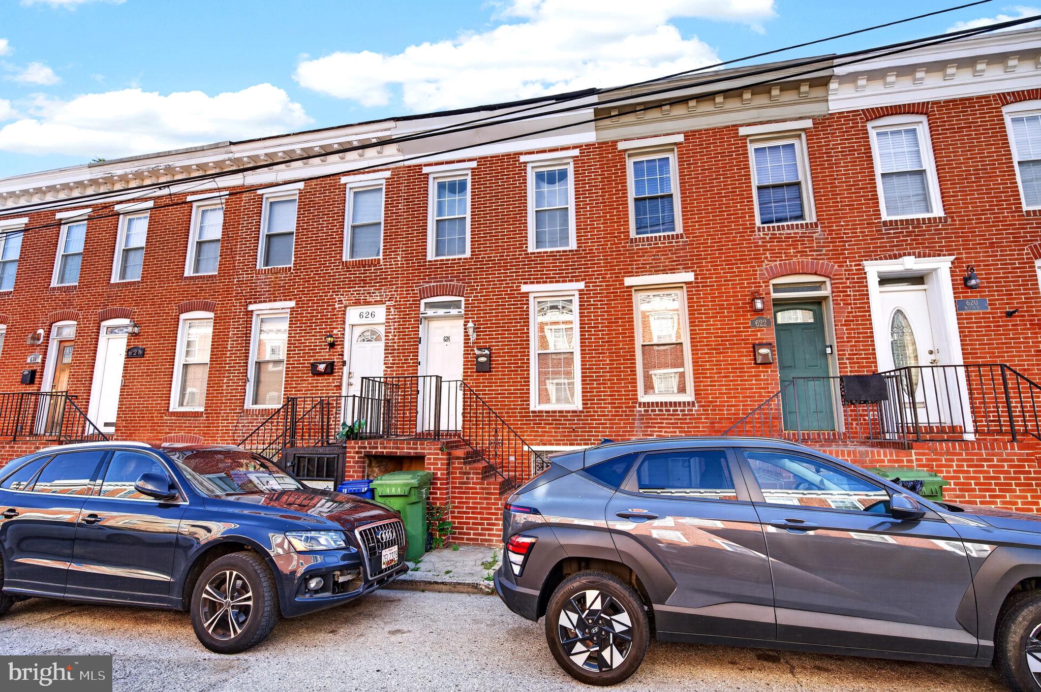 624 Wyeth St is a 2-bedroom, 2-bath rowhome in Washington Village with hardwood floors, exposed brick, a fenced patio, and a finished basement. You're getting more than the price suggests, and the neighborhood knows it.
The main level opens the way a rowhome should. Hardwood floors run throughout, exposed brick anchors the living area, and the kitchen has dark wood cabinetry and Corian countertops with enough workspace to actually cook. Plus in-unit washer and dryer at this price point. 
Upstairs is an open loft-style bedroom with its own full bathroom and a large closet. Downstairs, the finished basement has tall ceilings and is a perfect second full bathroom,  real usable space, not just storage with a coat of paint on it. Out back, a private fenced patio for summer nights. A few minutes to University of Maryland Medical Center, Carroll Park, the stadiums, and I-95. Pigtown isn't a secret anymore, but it's still priced like one. Schedule your showing today!