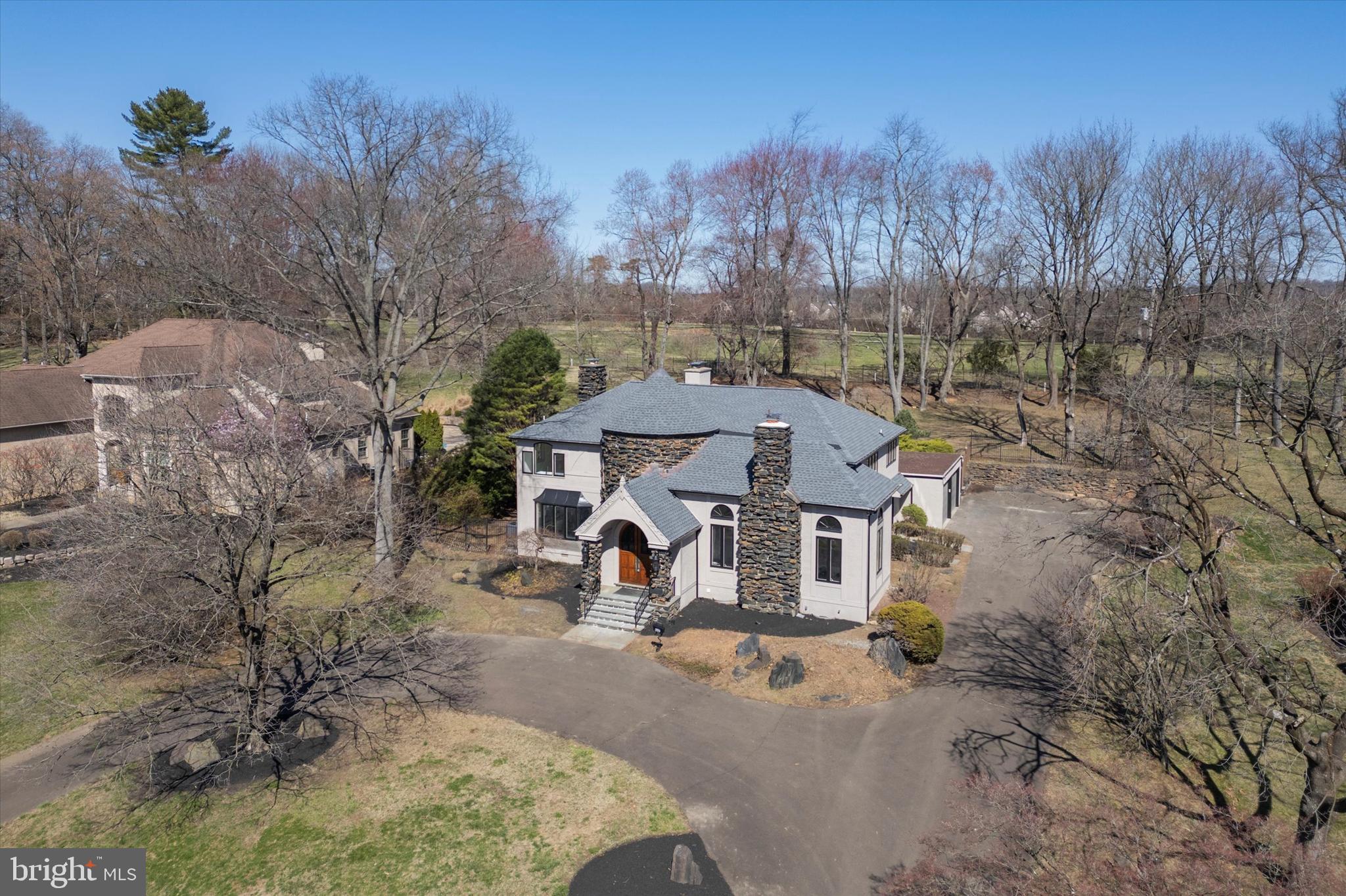 Welcome to 4127 Presidential Drive, a stunning transformation of a custom-built Tudor-style home, now fully renovated and waiting for its new owners! While maintaining its European charm, this home has been updated with modern sophistication and refined luxury. Situated along the 8th hole of Whitemarsh Valley Country Club, it offers breathtaking views and an exceptional living experience. As you arrive, the circular driveway and striking turret set the stage for what lies beyond. Enter through the grand antique double doors and step into a light-filled foyer with grand two and a half story ceiling height, beautifully detailed with hand-crafted inlaid wood. A curved wrought-iron staircase makes a stunning statement, leading to the second level. The formal living room is nothing short of spectacular, featuring a soaring cathedral ceiling, brand-new engineered hardwood flooring, and a magnificent wood-burning fireplace—the perfect centerpiece for cozy gatherings. Flowing seamlessly from here, the formal dining room is bathed in natural light. The expansive gourmet kitchen has been completely reimagined with custom white cabinetry, sleek quartzite countertops, and modern white appliances. It opens to a casual dining area with a brick gas fireplace and picturesque views of the backyard. A nearby hallway leads to the back staircase, a spacious laundry room, and a newly remodeled full bathroom. Adjacent to the kitchen, a bi-level family room offers abundant space for relaxation and entertainment. Large bay windows flood the room with natural light, while a built-in dry bar, a gas fireplace, and stunning backlit stained-glass inlays elevate the ambiance. Upstairs, you'll find four spacious bedrooms and three fully renovated bathrooms. The primary suite is an exquisite retreat, featuring a wood-burning fireplace, a walk-in dressing room and closet, a luxurious bathroom with dual vanity, soaking tub, a fully tiled stall shower with glass enclosure, and a private water closet with a built-in linen cabinet and a bidet. The second bedroom boasts its own ensuite bathroom with a tub/shower combo and full tile surround, while the third and fourth bedrooms share a beautifully updated hall bathroom. All bedrooms are spacious with a built-in closet and ceiling fan, and feature brand-new plush wall-to-wall carpeting. The fully finished basement offers additional living space, complete with a powder room, multiple storage areas, and walk-out access to the backyard. Step outside to your private outdoor retreat, where an in-ground pool awaits, surrounded by a flagstone patio—perfect for summer gatherings. A manicured lawn just beyond the pool overlooks the golf course, creating a serene and picturesque backdrop. Perfectly positioned near top-tier shopping, dining, and major highways, this home provides easy access to Center City Philadelphia and beyond. Don’t miss your chance to own this extraordinary blend of timeless charm and modern luxury. Schedule your private tour today!