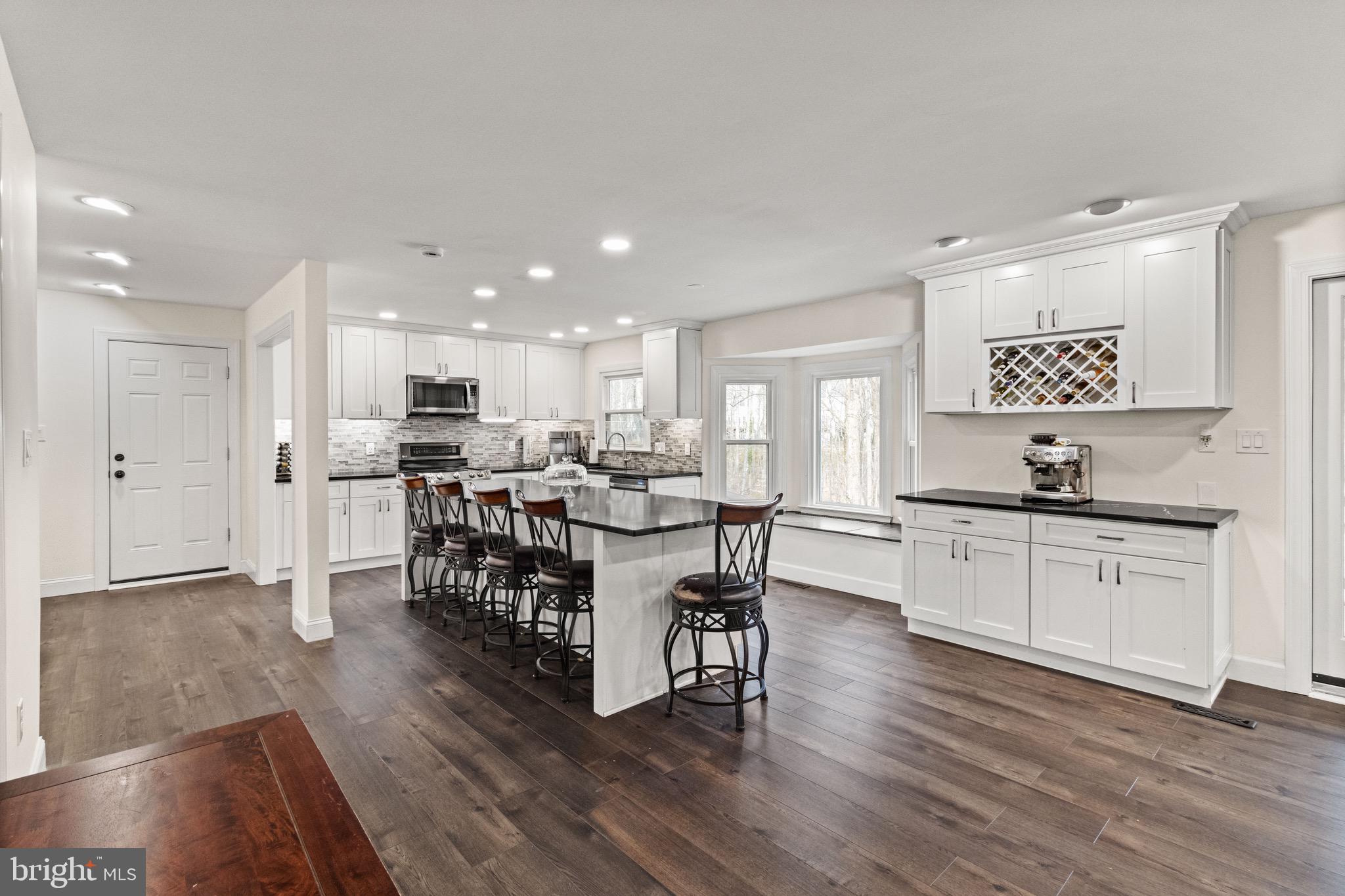 Located in a peaceful pipestem/cul-de-sac, this beautifully updated Burke home offers a large driveway and a two-car garage for ample parking. The property is set in a picturesque, park-like setting with a 1,200 sq. ft. multi-level deck and screened porch that overlooks tranquil woods and a gentle creek—perfect for relaxation or entertaining.

Inside, the remodeled eat-in kitchen features bright white cabinetry and an oversized island, creating a welcoming space for cooking and gathering. The finished walkout basement includes a spacious recreation room, full bath, and a den/optional 5th bedroom, offering flexible living options. Fresh paint throughout enhances the home’s bright and airy feel.

The primary suite boasts a generous walk-in closet and a beautifully renovated en suite bathroom with granite countertops. All bedrooms are spacious and well-appointed, providing comfort for everyone.

With scenic wooded views and a peaceful creek in the backyard, this home offers a serene retreat while being conveniently located near schools, parks, and amenities. A new roof will be installed before settlement for added peace of mind.

Please do not enter the garage during showings.

Zoned for Sangster Elementary and Lake Braddock Secondary School pyramids. Don’t miss this opportunity to own a stunning home in an ideal location!