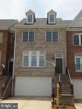 Beautiful brick-front townhome offering 2,445 finished square feet across three levels. This spacious home features 3 bedrooms, 2 full baths, and 2 half baths, along with an attached 2-car garage and a finished lower level providing additional living space. Move in with confidence knowing two major systems have already been updated—a new architectural shingles roof installed in 2025 and an HVAC system replaced in 2024.  This three-level bump-out townhome features an appealing living room and dining area accented with crown molding and wainscoting.  The gourmet kitchen features stainless steel appliances, a double wall oven, gas cooktop, abundant cabinetry, and generous workspace. Just off the kitchen, step onto the low-maintenance Trex deck.  Upstairs, the primary suite offers a private retreat with a tray ceiling, sitting area, two walk-in closets, and an en-suite bath featuring a jetted tub and separate shower. Two additional bedrooms and a full hall bath complete the upper level.  The finished lower level offers even more living space with a spacious recreation room, half bath, laundry room, and walk-out access to the fenced backyard.  Residents of Parks at Piedmont enjoy exceptional community amenities, including an upscale clubhouse, fitness center, business center, tennis courts, tot lots, walking trails, basketball courts, ponds, and parks. Ideally located in the heart of Gainesville, this home offers convenient access to I-66, shopping, dining, entertainment, and commuter routes.