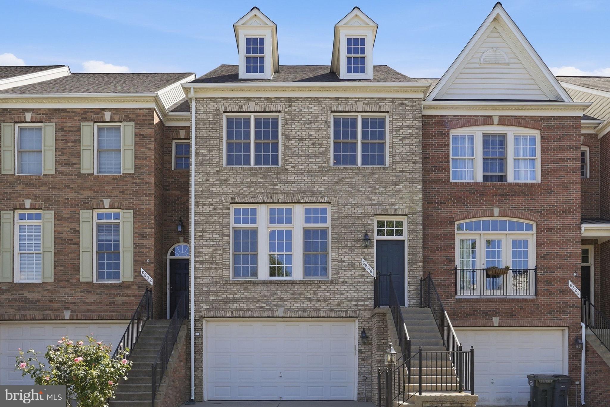 Beautiful brick-front townhome offering 2,445 finished square feet across three levels. This spacious home features 3 bedrooms, 2 full baths, and 2 half baths, along with an attached 2-car garage and a finished lower level providing additional living space. Move in with confidence knowing two major systems have already been updated—a new architectural shingles roof installed in 2025 and an HVAC system replaced in 2024.  This three-level bump-out townhome features an appealing living room and dining area accented with crown molding and wainscoting.  The gourmet kitchen features stainless steel appliances, a double wall oven, gas cooktop, abundant cabinetry, and generous workspace. Just off the kitchen, step onto the low-maintenance Trex deck.  Upstairs, the primary suite offers a private retreat with a tray ceiling, sitting area, two walk-in closets, and an en-suite bath featuring a jetted tub and separate shower. Two additional bedrooms and a full hall bath complete the upper level.  The finished lower level offers even more living space with a spacious recreation room, half bath, laundry room, and walk-out access to the fenced backyard.  Residents of Parks at Piedmont enjoy exceptional community amenities, including an upscale clubhouse, fitness center, business center, tennis courts, tot lots, walking trails, basketball courts, ponds, and parks. Ideally located in the heart of Gainesville, this home offers convenient access to I-66, shopping, dining, entertainment, and commuter routes.