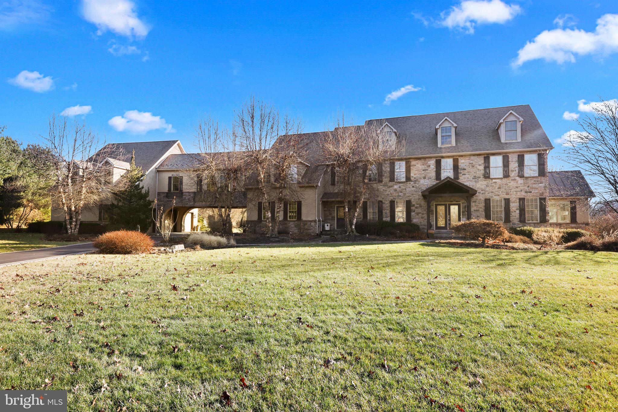 Welcome to 20 Stoudts Ln. This fabulous 5 bedroom, 5.5 bath home sits at the edge of the mountains on 6 acres in a gated community.  Drive up to the house through a gated entrance that is secured every evening. The first floor boasts a two story foyer, 19 ft ceilings in the family room with large windows and views of the mountains and fireplace, kitchen with breakfast nook, sunroom, office, dining room, sitting room, powder room, garage access and laundry. The second floor has 4 bedrooms.  The primary bedroom including the primary bath and closet is over 1000 sf. A large sitting room and gym complete this suite.  The third floor is a massive bedroom with a full bathroom.  The lower level is the ultimate entertainment floor. Stone walls encase a full wet bar with fireplace, family room, gameroom, card room, pool room with copper tray ceiling and a 12x11 wine room that holds hundreds of bottles of your finest wine. A full bathroom is available and outdoor access to a fire pit.  The amenities of this home are endless: 3 zone HVAC, 6 car garage, heated driveway, breezeway connecting main house to garage, 2 laundry rooms, 2 putting greens, heated in-ground pool, crown molding, sauna, double staircase, cat walk overlooking the family room. The photos speak for themselves; this is a home you must see in person to believe. Call today to schedule!