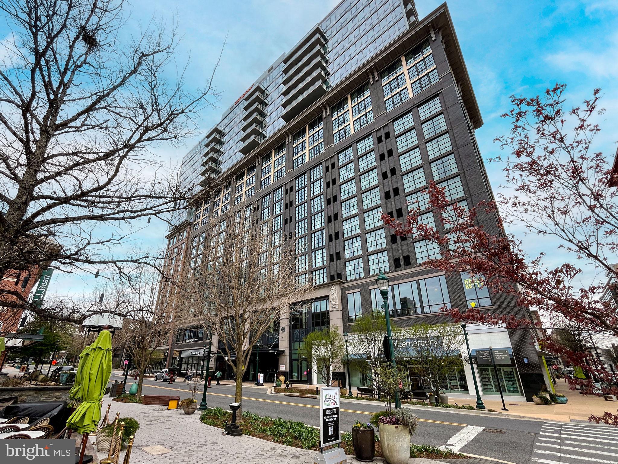 Luxury Living at Pike & Rose! Welcome to Unit 1701 at 930 Rose Avenue, a stunning 2-bedroom, 2-bathroom corner residence in the heart of North Bethesda. This modern high-rise condo boasts floor-to-ceiling windows that flood the space in natural light while offering breathtaking city views.

The open-concept design features wide-plank hardwood flooring and a chef’s kitchen complete with a cascading quartz island with bar seating and sleek stainless steel appliances, perfect for cooking and entertaining.

The primary suite offers a spa-like bathroom with dual sinks and a generous walk-in closet, while the second bedroom provides flexibility for guests or a home office. Additional highlights include an in-unit washer and dryer for ultimate convenience. This unit also has a storage unit in basement and one assigned parking space in parking garage. 

Enjoy top-tier amenities, including a rooftop lounge, fitness center, and 24-hour concierge. Just steps from dining, shopping, and entertainment at Pike & Rose and minutes from Metro, this is urban living at its finest. Don’t miss this rare opportunity!
