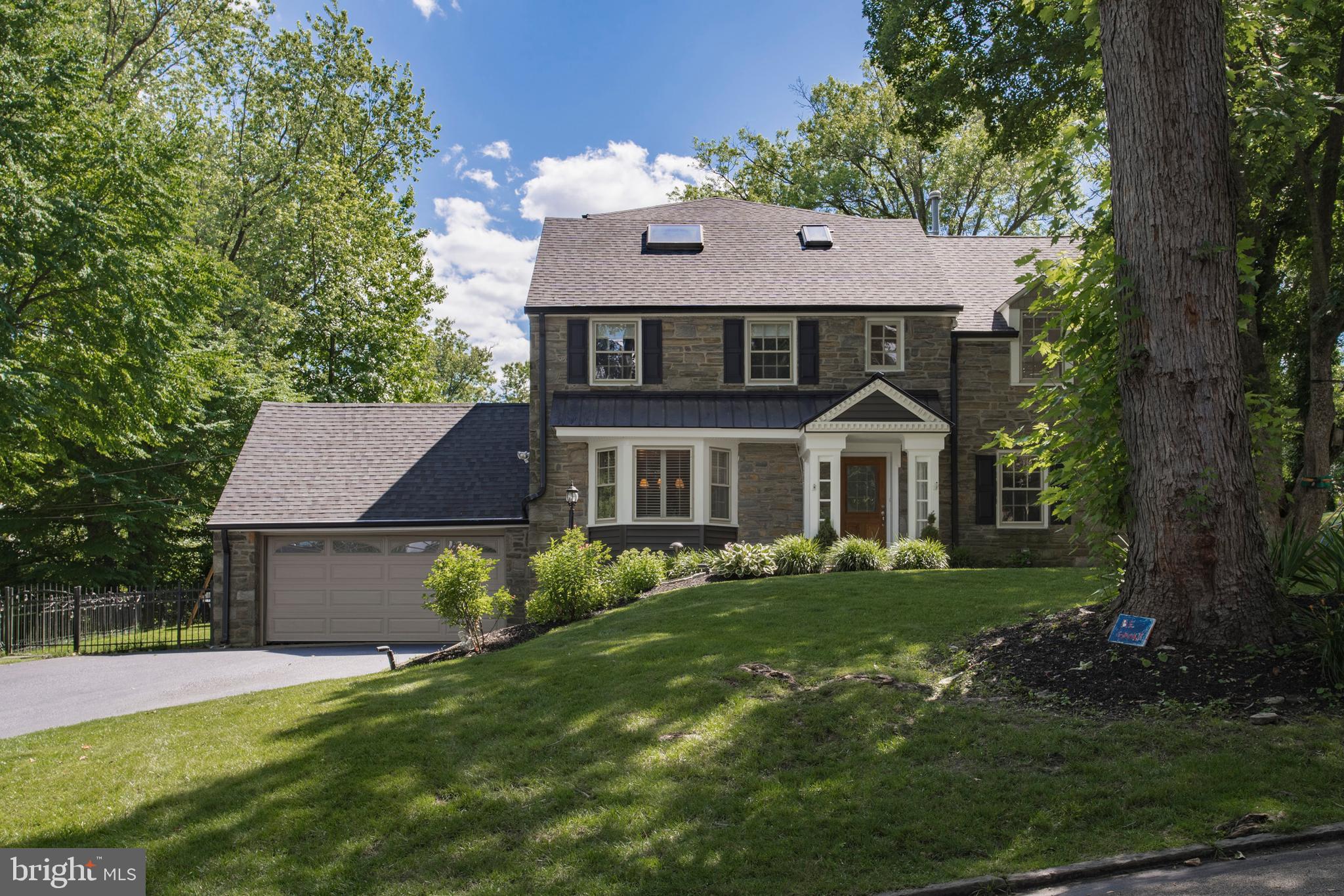 Wonderful opportunity has come to the Main Line Market , located on a beautiful , quiet, tree-lined street in one  of Wynnewood's most desirable neighborhoods . This beautiful Stone Colonial is located on a corner lot , it has been updated blending today's modern conveniences with the gracious old world charm.  With over 3,800 square feet of wonderful living space plus and additional 1600  square feet off finished lower level and a  detached two car garage this home offers a seamless floor plan that flows throughout .  The stone steps pathway and landscaped flower beds lead the way to a charming main entrance.  From the moment of entry , you will be welcomed to stunning hardwood floors , chair rail molding and chef's kitchen with an open concept that flows into the family room and has direct access to the deck , play area and a completely fenced in side and backyard.  The warm and welcoming Living Room featuring a bay window and lovely window seat  has direct access to a charming office/study  with floor to ceiling built in bookcases .The  Formal Dinning Room  has wonderful light to enhanced your dinning experience . The second  floor offers an expanded Master Bedroom  Suite with great  closet space as well as an office area with built -in bookcases, marble bathroom shower and double sinks complement the Master Bath . There are two more beautiful Bedrooms on this floor , additional 2 full Bathrooms and  Laundry room.  The third floor offers two additional Bedrooms one with vaulted ceilings and a full Bath.  A finished Lower Level has built-in cabinets and bookcases as well as a separate room for exercise ,   storage space and another half bathroom.  Situated in the award winning Lower Merion School District and settled in the heart of Wynnewood close to shopping, restaurants, public transportation , parks and Center City.  Schedule a showing to come and explore your forever home today!