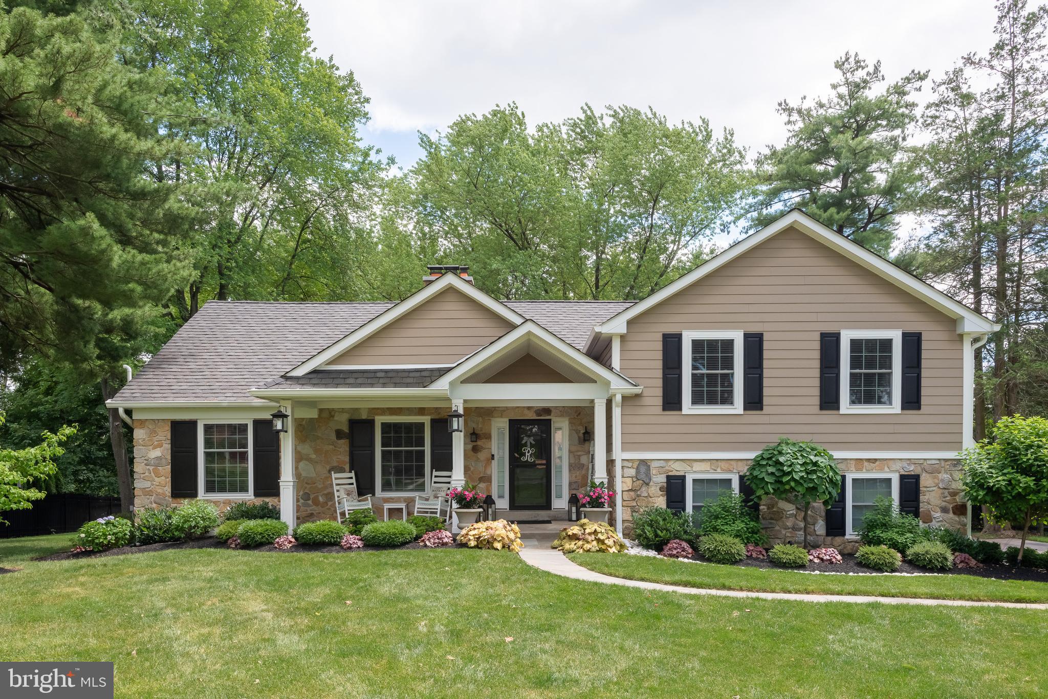 Welcome to 552 Gulph Road, a gorgeously updated home offering FIVE beautifully finished living levels in Glenhardie, one of the most sought after neighborhoods on The Main Line. Situated on a fantastic lot with a wonderful, deep rear yard, this is a terrific property, both inside and out. This exceptional home is just steps from Valley Forge National Park. A rare opportunity to own a fully updated home in a prime neighborhood within the top ranked Tredyffrin-Easttown School District. The covered front porch leads to the spacious living room which features a wood burning fireplace with classic Colonial mantle. The heart of the home is the gourmet kitchen offering a large granite topped center island with pendant lighting, plenty of cabinet space, under cabinet lighting, granite countertops with a subway tile backsplash, a double stainless steel sink, stainless steel appliances, a pantry and a wall of exposed brick with a second wood burning fireplace. An open concept dining area off the kitchen offers a sliding glass door opening to a huge, low maintenance deck overlooking the rear yard. The second level is home to the owner's suite which features two double closets and a sumptuous owner's bathroom with a soft finished granite vanity with twin sinks, tile flooring and a huge shower with river rock flooring and walls plus a seamless glass door. Two additional bedrooms, each with double closets, are serviced by a beautifully renovated hall bathroom with a quartz topped vanity and subway tiled shower. The third floor loft/bedroom suite also has a double closet and is serviced by its own bathroom with updated marble vanity and tile shower floors and shower with a seamless glass entry. The lower level family room is a terrific finished space offering a custom wet bar with wine rack and beverage refrigerator, a powder room plus double sliding  glass doors to the walkout patio area. A mudroom with built in seating bench and cubbies, coat hooks and a double closet leads to both the side driveway and the two car garage. The laundry area is perfectly situated on this level. Unlike the vast majority of the homes of this style, 552 Gulph Road has a fully finished basement area along with a huge unfinished storage room. The spectacular lot offers mature plantings, professionally landscaped front and rear garden beds and plenty of yard space to play, and is equipped with an electric fence around the front and rear yards. The deck is the ideal spot for entertaining, grilling and dining al fresco. A gorgeous stone patio with a built-in  natural gas firepit is perfect for late night relaxing and conversation. Note that the patio is pre-wired for a hot tub, if so desired. Hardwood flooring, recessed lighting,  tremendous closet, attic and storage space, ceiling fans in all four bedrooms, nice millwork, multiple outdoor living areas, an open concept floor plan, tasteful color choices and so much more all come together to make 552 Gulph Road a very, very special place to call home.  Watch the four seasons unfold from every window in this beautiful area near historic Valley Forge Park. Close to Trader Joes, Wegmans, the King of Prussia Town Center and the shops, restaurants, and trains of the Main Line. Truly a once in a lifetime opportunity.  This is the one. Welcome home!