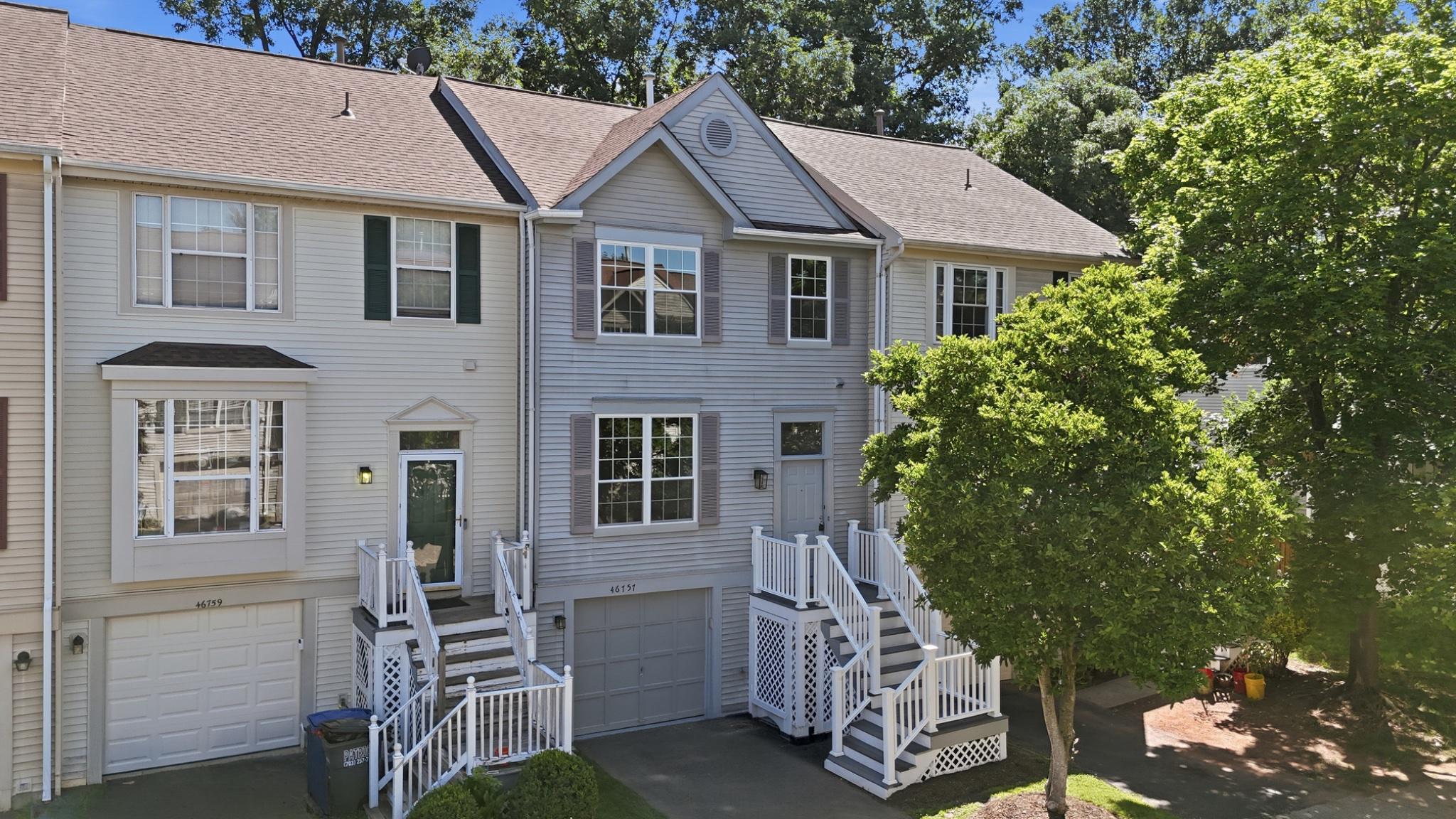 Welcome to 46757 Hobblebush Terrace, a beautifully renovated three-level townhome tucked away on a quiet cul-de-sac within the highly sought-after Woodstone of Loudoun community. Backing to mature trees and offering exceptional privacy, this move-in ready home combines thoughtful modern upgrades, peaceful outdoor living, and an unbeatable Sterling location. Offering approximately 1,762 square feet of finished living space, the home features 3 bedrooms, 2 full bathrooms, 1 half bathroom, and a fully finished walkout lower level.

The main level has been completely transformed in 2026 and showcases refinished hardwood flooring, fresh paint throughout, recessed lighting, and a stunning redesigned kitchen that serves as the heart of the home. The brand-new kitchen features white shaker cabinetry, quartz countertops, stainless steel appliances, a large center island, custom pantry and coffee station, subway tile backsplash, and an open-concept layout ideal for both everyday living and entertaining.

The upper level offers a spacious primary suite with a fully renovated primary bathroom completed in 2024, along with a beautifully updated secondary full bathroom also renovated in 2024. Generously sized bedrooms, updated finishes, and abundant natural light create comfortable and inviting living spaces throughout.

The fully finished walkout lower level provides exceptional flexibility and can easily serve as a recreation room, home office, gym, media room, playroom, or guest retreat. Direct access to the rear yard creates seamless indoor-outdoor living.

Major capital improvements provide peace of mind, including a roof replacement in 2018, all new windows installed in 2026, brand-new kitchen appliances (2026), brand-new washer and dryer (2026), whole-house interior paint (2026), and extensive backyard improvements completed in 2026.

Step outside to enjoy the newly landscaped and fenced rear yard featuring fresh sod, decorative stone accents, and space for outdoor relaxation beneath the elevated deck. The private wooded backdrop creates a tranquil setting rarely found in townhome living.

Residents of Woodstone of Loudoun enjoy access to community amenities including an outdoor swimming pool, tennis courts, basketball court, tot lots, playgrounds, and common green spaces.

Ideally located in the heart of Sterling, this home offers convenient access to Dulles Town Center, Cascades Marketplace, Tysons Corner, Reston Town Center, Claude Moore Recreation Center, Algonkian Regional Park, Washington Dulles International Airport, the Silver Line Metro, Route 7, and Route 28. Enjoy close proximity to shopping, dining, entertainment, parks, commuter routes, and some of Northern Virginia’s premier destinations.

A rare opportunity to own a thoughtfully renovated, turnkey home in one of Sterling’s most desirable and convenient communities.