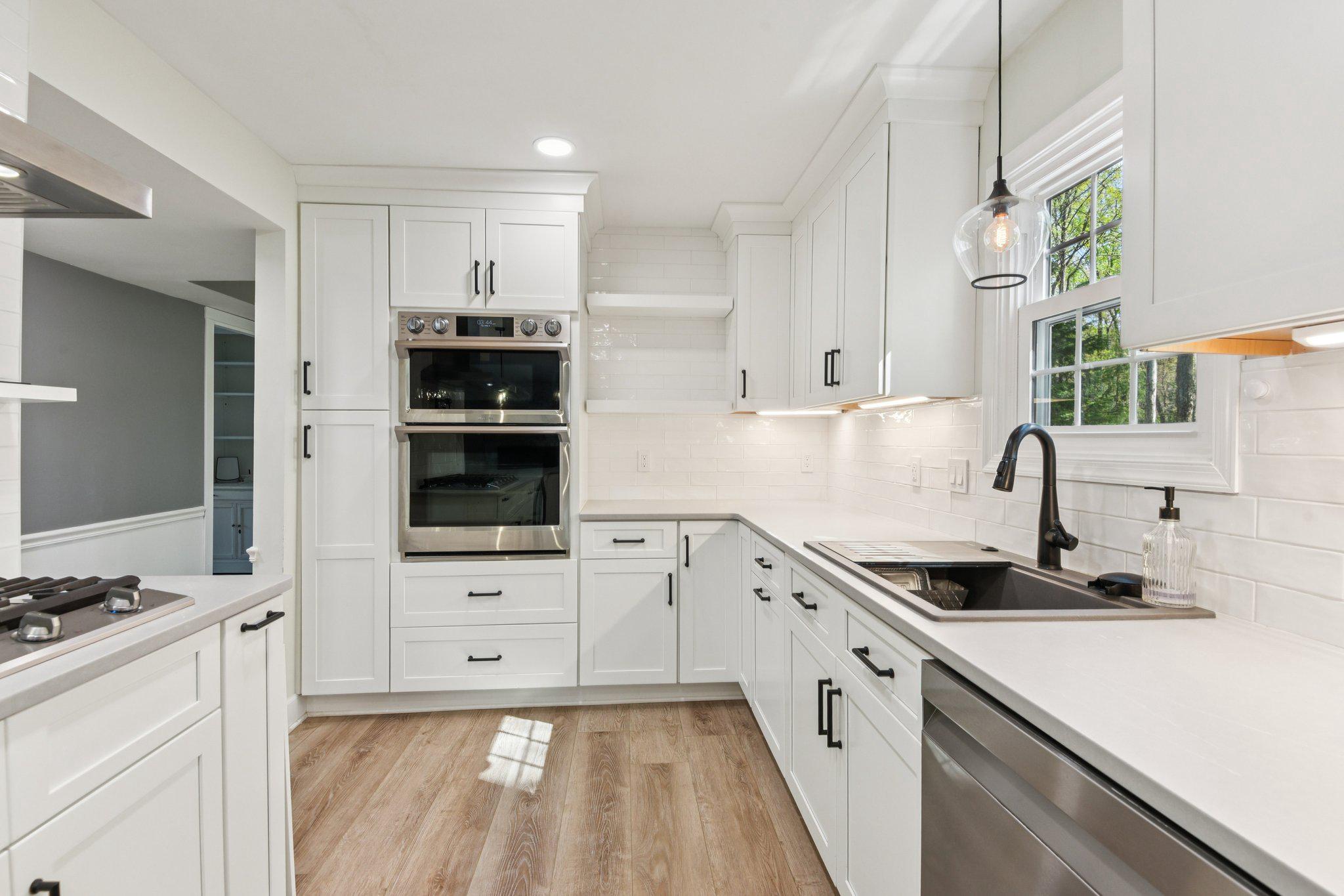 Hidden Cove has no Age Restrictions.  Fully updated and move-in ready, this impressive 5-bedroom, 3.5-bath home offers a finished lower level complete with a bedroom and full bath—ideal for guests, extended living, or a private retreat. The 2022 renovated kitchen is the heart of the home, featuring quartz countertops, soft-close cabinetry, and premium Samsung appliances, seamlessly connecting to the main living and dining areas. All three full bathrooms have been tastefully updated within the past four years, including a spa-inspired primary suite showcasing a soaking tub, rainfall shower, heated towel rack, dual LED vanities, and a cozy electric fireplace heater. Major system upgrades provide peace of mind, including a new electrical panel (2022), Bosch dual-fuel HVAC system (2023), new luxury vinyl plank flooring (2023), all windows replaced, and water heater (2020). Smart home enhancements include a security system, sensors, and hardwired detectors. The finished lower level is designed for both function and entertaining, featuring a dry bar with full refrigerator and cleverly concealed storage. A dedicated home office with Restoration Hardware furnishings adds both style and productivity, while Elfa closet systems throughout maximize organization. Outdoor living is equally impressive with over $30,000 in hardscaping, including an engineered retaining wall, paver patio with gazebo, main-level deck, and a private wooded backdrop. Additional highlights include an upgraded garage with built-in cabinetry, utility sink, and EV wiring. Condo classification offers the benefit of reduced exterior maintenance and sometimes lower insurance costs. Located in the non-age restricted section of Heritage Harbour, residents still have the option to enjoy access to the community’s extensive amenities.  Amenities include golf course membership, indoor and outdoor pools, tennis courts, fitness center, clubhouse, boat ramp, water access, and a wide range of social and recreational offerings with a voluntary membership to Heritage Harbour.  This home delivers the perfect combination of space, upgrades, and lifestyle.