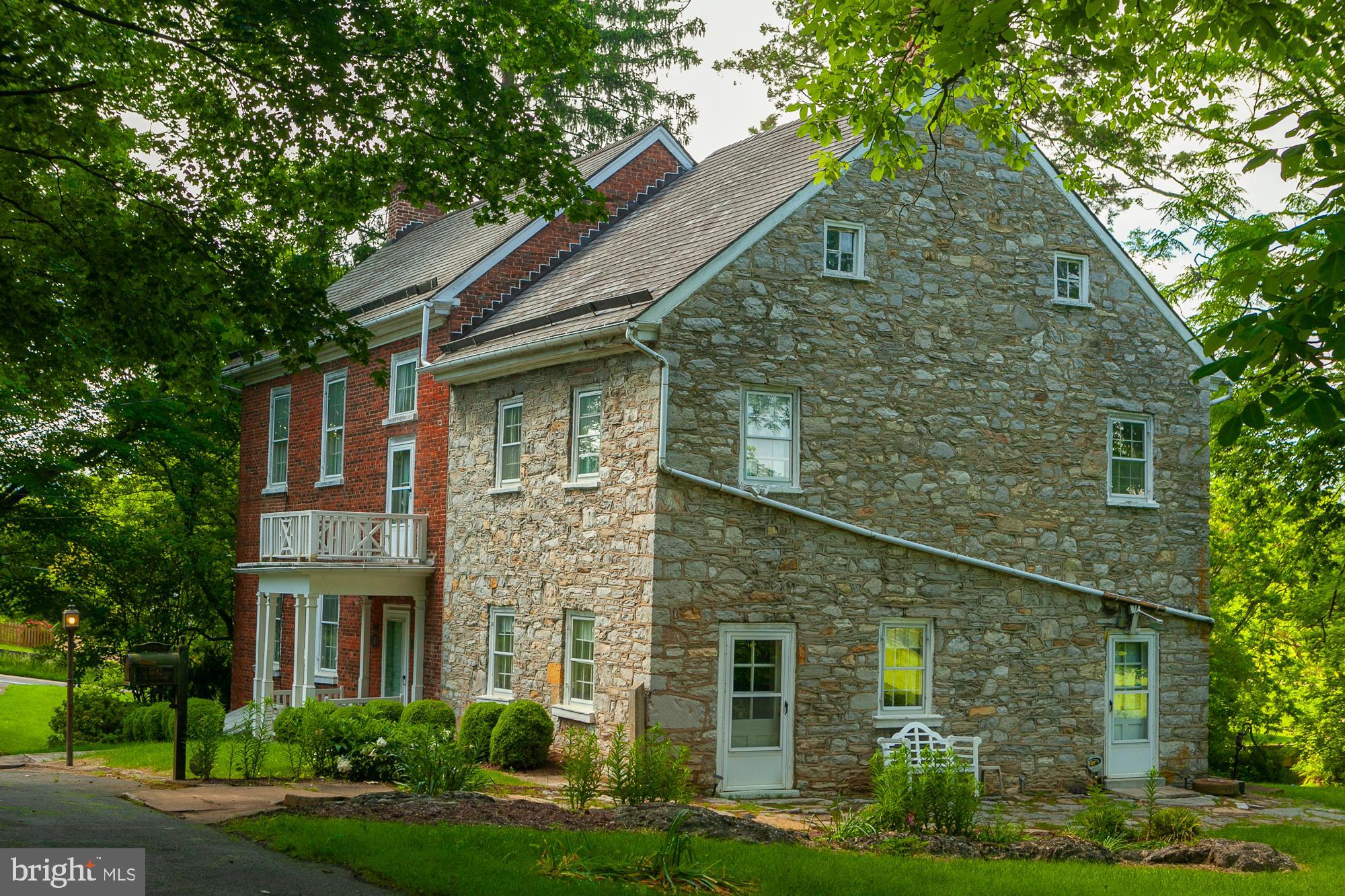Huxley Hall - Circa 1782
"A World Apart"

Rare opportunity to own this stunning historic brick and stone home, spanning 3,648 Sq.Ft., overlooking Tuscarora Creek (creek included!) on 13.4 acres right in the town of Martinsburg. This property, with only four owners (including a Revolutionary War Captain) and owned by the Townsend family for over 60 years, is now on the market.   In the public record it appears the house was sold 2 years ago  however this was a division of the inheritance by the heirs  and does not reflect in any way the value of the property. 
Features:

    Historic Charm: Built in 1782, this elegant yet comfortable home is perfect for family and friends.
    Spacious Interiors: 10-foot ceilings, original wood floors, and four fireplaces.
    Outdoor Living: Double porches for relaxing with views of Tuscarora Creek and the pasture area.
    Meticulously Cared For: The home has been carefully maintained.
    Additional Buildings: Includes a stone spring house and a detached 3-car garage with a separate office or workshop area.
    Nature at its Best: Enjoy the symphony of birds, bees, and butterflies in this magical, private setting with mature trees and partly wooded areas.
    Recreational Opportunities: Fish in your own side yard and keep horses or cattle on the property.

Convenient Location:

    Close to I-81, Exit 13
    Near WV University Hospital
    Proximity to War Memorial Park, Malls (Foxcroft Town Center, The Commons)
    Minutes to downtown Martinsburg and the MARC commuter train to DC

Additional Information:

    Extensive historic documents will convey with the property.
    Floor plans included in the listing.
    Interactive 3D video available for virtual tours.

Exceptional in every way, Huxley Hall offers a rare blend of historic elegance and modern convenience. Don't miss out on this unique opportunity to own a piece of history in Martinsburg.