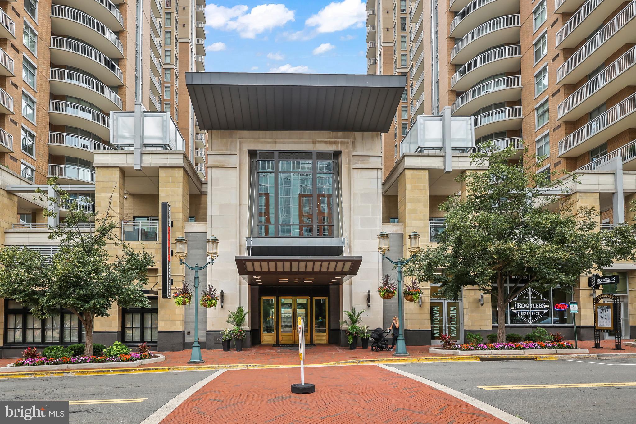 Experience elevated living in the heart of Reston Town Center in this beautifully updated luxury condo, where sophisticated design meets unmatched convenience. The stunning modern kitchen is a true showpiece, featuring premium Miele and Bosch appliances, an induction cooktop, built-in refrigerator, custom cabinetry, and a Miele washer and dryer. New engineered hardwood flooring flows throughout, while thoughtful custom touches—including a built-in walk-in closet in the spacious primary suite and built-in bookshelves in the den—add both style and function. Unwind in the beautifully renovated primary bath with a sleek full-glass shower and Kohler thermostatic shower system. At Midtown, every day feels like a resort with exceptional amenities including 24/7 concierge and security, package handling, a fitness center with massage room, outdoor pool and hot tub, grilling terrace, private theater, furnished guest suites, party room with kitchen, conference room, heated garage, and indoor guest parking. Step outside to enjoy the vibrant lifestyle of Reston Town Center with its premier shopping, dining, entertainment, green spaces, the W&OD Trail, and the Reston Town Center Metro just moments away. Luxury, comfort, and an unbeatable location come together to create a truly exceptional place to call home.