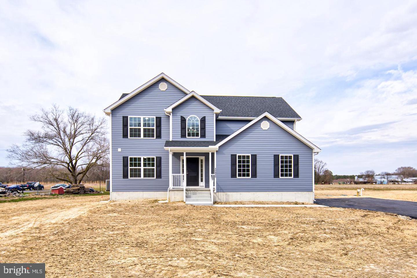 Discover the freedom of country living with no HOA and no Deed Restrictions on this stunning custom home situated on a private, wooded 0.76-acre lot. Conveniently located near Route 113, Route 1, and Delaware’s beautiful beaches, this property offers endless possibilities—bring your boat, RV, build a detached garage, add a pool, or create the outdoor oasis you've always envisioned. Offering approximately 2,400 square feet of thoughtfully designed living space, this 4-bedroom, 2.5-bath home combines modern style with everyday comfort. Luxury vinyl plank flooring enhances the foyer, kitchen, breakfast area, and bathrooms, while the bright, open-concept floor plan is perfect for both entertaining and daily living. The spacious family room flows seamlessly into the gourmet kitchen, featuring 42-inch soft-close cabinetry, quartz countertops, and a stainless-steel appliance package. At the front of the home, a versatile flex space provides the ideal setting for a formal dining room, home office, or additional living area. Upstairs, retreat to the expansive primary suite complete with a spa-inspired ensuite bath featuring a soaking tub, oversized shower, double vanity, and generous closet space. Three additional bedrooms, a full hall bath, and a conveniently located second-floor laundry room complete the upper level. The full unfinished basement offers unlimited potential—finish it to create additional living space, a home gym, media room, or workshop, or simply enjoy the abundance of storage. Don't miss this rare opportunity to own a beautiful custom home with room to grow and the flexibility to truly make it your own. Schedule your private tour today!