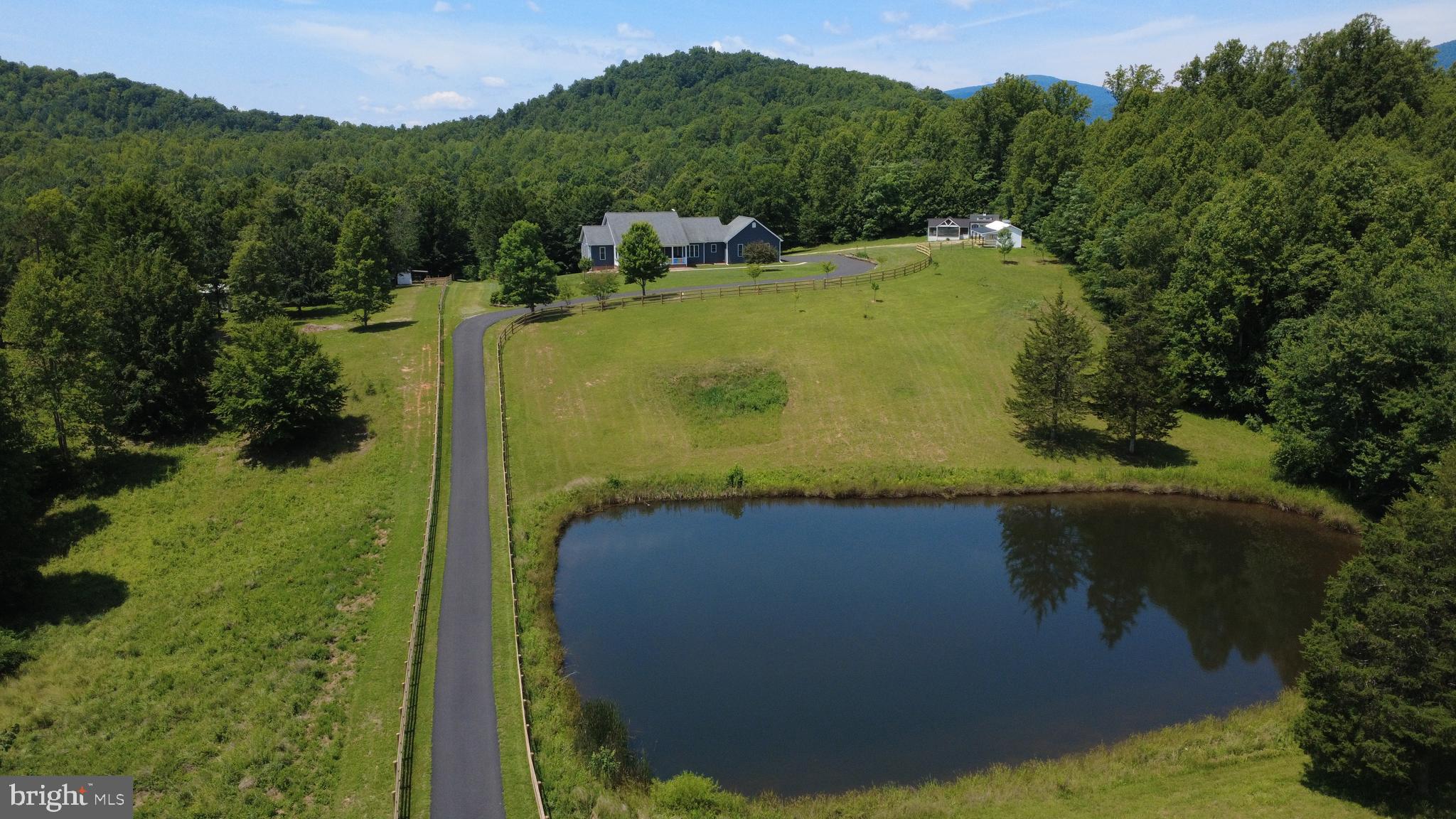 Welcome to your private Virginia estate, where sweeping pastoral views, rolling pastures, & modern conveniences come together on more than 42 acres of thoughtfully improved land. This rare turnkey property offers an unmatched combination of privacy, infrastructure, & natural beauty, featuring a spring-fed pond, multiple streams, miles of trails & bridle paths, abundant wildlife, & breathtaking scenery in every direction.

The 5,400+ sq ft residence offers 6 bedrooms, 5.5 bathrooms, & two primary suites, including a lower-level suite w/ private exterior access. Recent improvements include a newly paved driveway, newer appliances, major system upgrades, high-speed fiber internet, security monitoring, smart exterior lighting, & individualized heating controls.

Whether your vision includes horses, hobby farming, homesteading, outdoor recreation, or simply enjoying a peaceful rural lifestyle, extensive infrastructure is already in place, including expansive fenced pastures, a new 2-stall horse barn w/ tack room & electric, multiple run-in shelters, a large chicken coop, & a 48x48 pole barn.

No HOA. The property is protected by a conservation easement that helps preserve the scenic views, privacy, & rural character that make this estate so special while providing significant property tax advantages. The easement permits continued residential, agricultural, equestrian, & recreational use, allowing owners to fully enjoy the land while helping ensure its natural beauty endures for generations. Select furnishings, a Kubota tractor w/ attachments, & zero-turn mower are negotiable.

Conservation easement document attached. Easement preserves open space and prevents future subdivision while permitting residential, agricultural, equestrian, and recreational use. Significant property tax advantages. Potential additional homesite (buyer to verify). Please review easement documentation prior to scheduling showings.