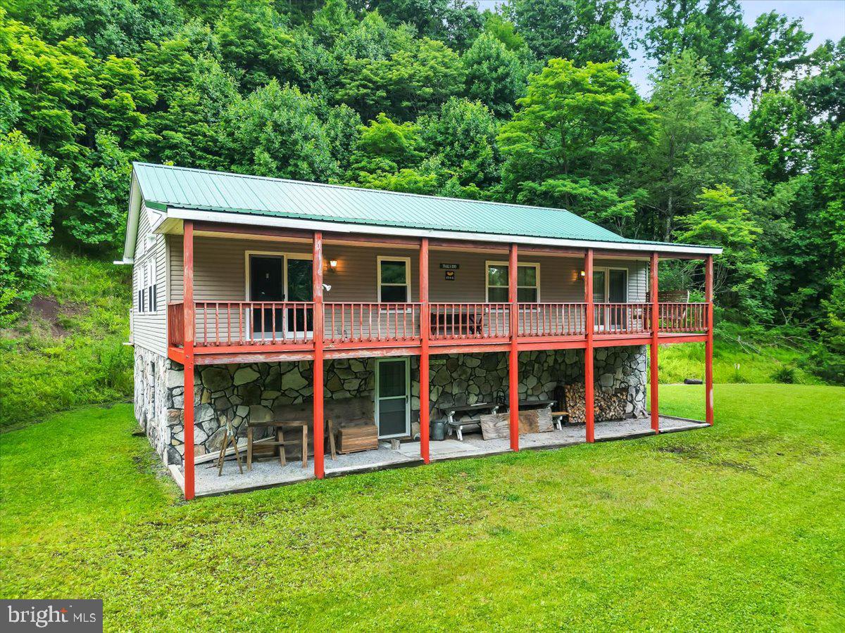 Nearly 50 acres just minutes from Deep Creek Lake! Discover an exceptional opportunity to own two wooded parcels totaling almost 50 acres in one of Garrett County's most desirable locations. Whether you're searching for a private mountain retreat, hunting property, recreational getaway, or future investment, this property offers incredible potential and room to make it your own.

Tucked among the trees, the existing 3-bedroom, 3-bath home offers nearly 2,500 square feet with vaulted ceilings, spacious living areas, a large kitchen, wood-burning stove, covered front porch, expansive composite deck, partially finished walkout lower level, and an oversized garage with workshop. The home is functional but ready for updates, making it an ideal project for someone looking to renovate, expand, or build equity.

The real showstopper is the land. Enjoy nearly 50 acres of mature woods with abundant wildlife, established ATV and hiking trails, and the privacy that's becoming increasingly difficult to find. The property has been recognized as a Certified Wildlife Habitat and offers endless opportunities for hunting, recreation, or simply enjoying the peaceful mountain setting.

Located just minutes from Deep Creek Lake, Wisp Resort, state parks, golf, restaurants, and year-round recreation, this is a rare chance to own a substantial piece of Garrett County with unlimited potential. Whether you restore the existing home, create a family compound, or simply enjoy the acreage as your private escape, opportunities like this don't come along often.

Roof and Windows Updated in the Last 10 Years!  Generator covers most of the house and has never been used but conveys with the sale! The electric to the house has enough capacity for 3 additional homes. The property has been timbered twice, and it's ready again, so the new owners could have it timbered, and the timber company will build timber trails to improve the driveway! HOA exists only on the 2nd 10 acre parcel and is for road maintenance!
