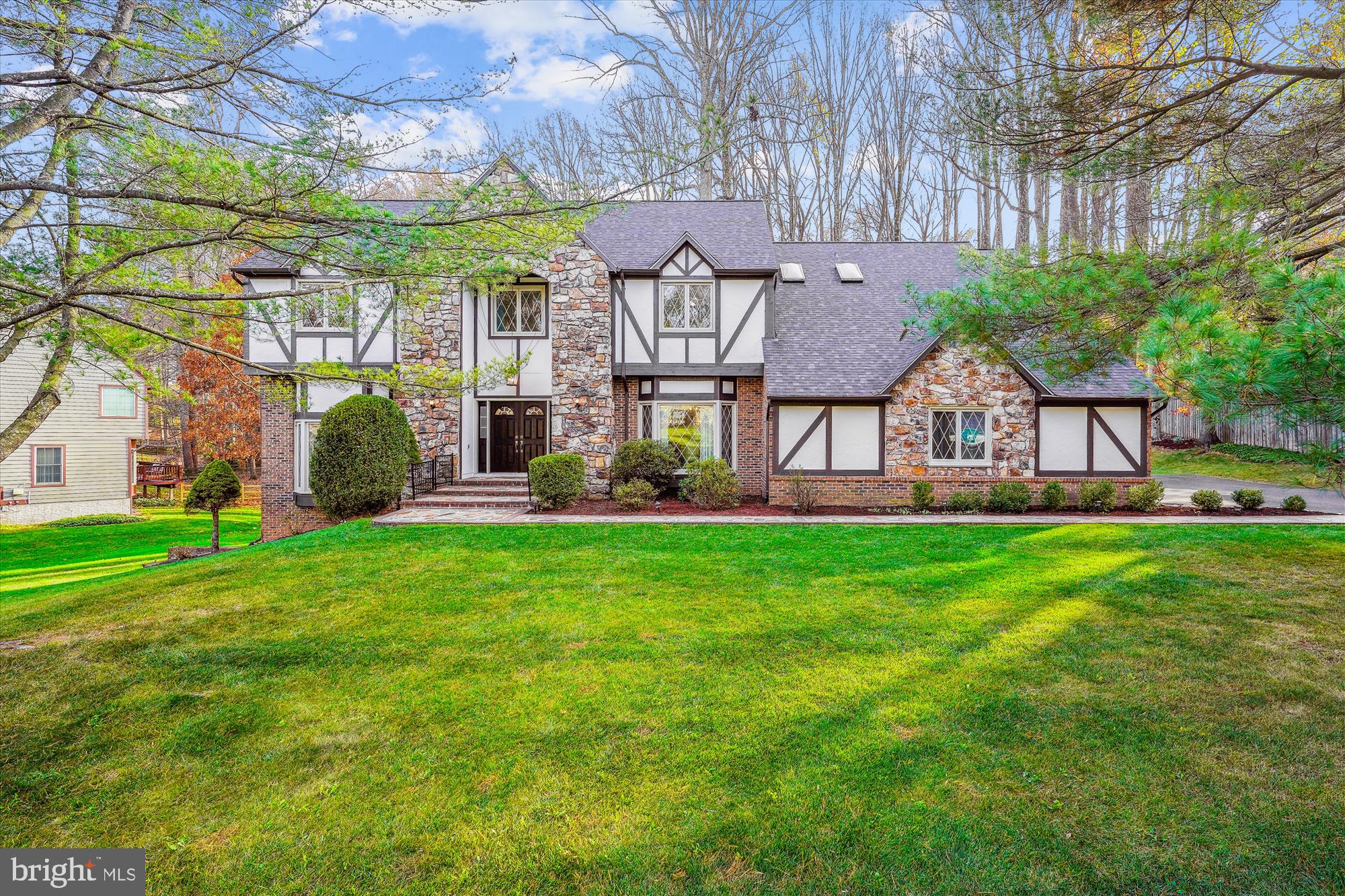 Welcome to 10319 Hickory Forest Drive, an enchanting storybook Tudor in the heart of Oakton. This updated residence features six bedrooms and 4.5 bathrooms, offering over 6,200 square feet of smart living space and a versatile floorplan with the sought after 5 bedroom/3 bath configuration on the upper level.

The impressive curb appeal is equally matched by the beautiful and impressive interior.  Enter the gracious marble foyer with an elegant circular staircase, flanked by the formal living room and dining room that are perfect for special occasions.  The main level library is ideal as a work from home option.  The gourmet kitchen with breakfast nook opens to the family room with expansive stone fireplace for cozy evenings by the fire.    Ascend to the upper level with the coveted 5 bedroom/3 bath configuration including a spacious primary with renovated, luxurious spa bath, a guest suite with  attached bath, and 3 additional large bedrooms that share a hall bath.  The walk out lower level is fully renovated and boasts a bedroom, rec room with fireplace, a soundproof theater with snack bar, and durable LVP flooring throughout.

The .72 acre lot has been specially graded to add flat play space accented by beautiful trees.  The screened in gazebo is a wonderful spot to enjoy the great outdoors, and the benefits of living in a quiet neighborhood surrounded by nature.  The large lot size coupled with public water and sewer offer options for a pool.

Meticulously maintained property with important updates including: Roof (2021), HVAC, Furnace and Hot Water Heater (2017),  Windows & Siding (2013). 

Exceptional location is close to it all, but feels a world away.  Minutes to the Oakton Shopping Center with a Giant, CVS, Starbucks and restaurants.  Excellent commuter location - 3 miles to the Vienna Orange Line Metro and convenient to major commuter routes - 66, 495 and the 267 Toll Road.  Nearby community amenities include a playground, the library and Oakmont Rec Center with indoor pool, gym, mini-golf, a driving range and 9-hole golf course.

Award winning school pyramid:  Oakton Elementary, Thoreau Middle, Oakton HS.