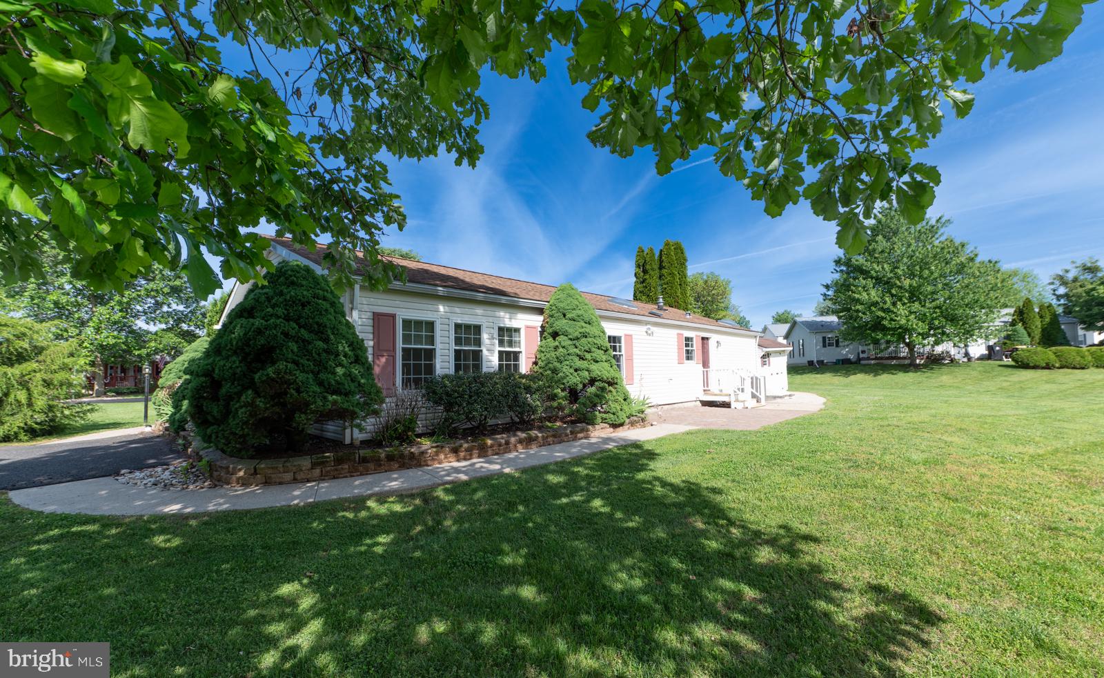 Bright, airy, and move‑in ready—this charming home in the sought‑after 55+ community of Willow Run offers the easy lifestyle you’ve been looking for. Enjoy one of the best locations in the neighborhood, directly across from the community pool and clubhouse.  This rare three‑bedroom, two‑bath layout features the open floor plan everyone wants. The spacious kitchen stands out with creamy white cabinetry, upgraded granite countertops, a full appliance package, and an oversized pantry tucked into the utility area.  The living room feels expansive with its cathedral ceiling and recessed lighting, creating a comfortable space for everyday living and entertaining.  The primary bedroom ensuite offers generous closet space and a full bath with an oversized walk‑in shower. The two additional bedrooms are thoughtfully positioned on the opposite side of the home—ideal for privacy. One makes a wonderful sunny reading nook or office, while the other is perfect for guests. A well‑appointed hall bath with a tub/shower combination serves this wing.  A side door leads to the paver patio—perfect for quiet evenings under the stars with nothing but nature as your backdrop.  There is also a shed for added convenience and storage.....There is central air, and natural gas forced hot air when the weather turns cooler, along with all appliances makes this a winning home!   An AHS Home warranty will be our gift at settlement with the purchase of this property.