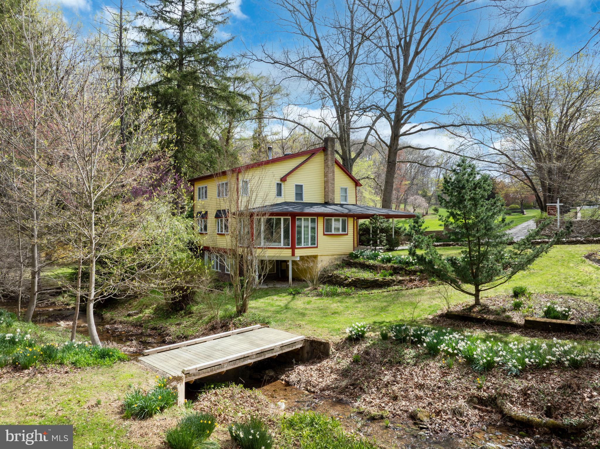 Your Private 41.9 Acre Nature Retreat Awaits!  Experience the peace and privacy of this property, a true hidden gem surrounded by the beauty of nature. A wooded gravel road leads you down to the main home, where you’ll be greeted by the sights and sounds of birds, wildlife, and the gentle flow of a nearby creek. The inviting 3 bedroom, 1.5 bath home offers a warm, welcoming atmosphere with hardwood floors, cozy carpeted areas, and a wood-burning fireplace perfect for chilly evenings. The kitchen and dining area provide a wonderful space for meals with serene views of the creek, while the deck offers an ideal spot to sip your morning coffee or unwind with a book as you overlook the trees and yard. The first floor laundry in the half bath adds everyday convenience, and the carport makes parking easy. Outside, the property continues to impress with natural and recreational features, a charming bridge crossing the creek, a small waterfall tucked deeper into the woods, and even an old dirt bike trail ready for exploration. Enjoy a tranquil fish pond with goldfish and a spacious barn, perfect for hay storage or hobby use. The barn also features a separate entrance, adding flexibility for various uses. Whether you’re looking for a peaceful getaway, a working homestead, or a place to enjoy the outdoors, this property offers a rare opportunity to own your own piece of paradise. Don’t miss your chance to make this unique retreat yours!