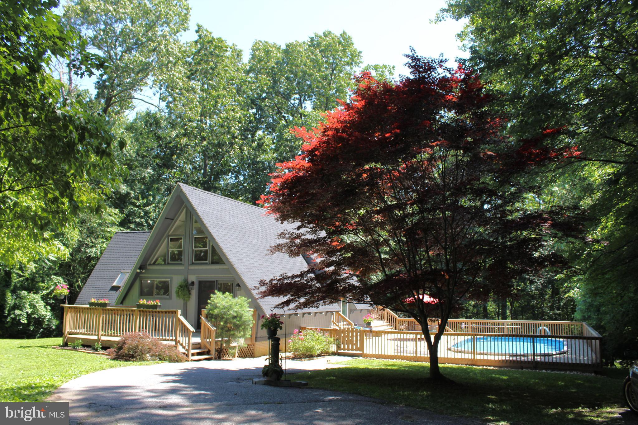 RARE OPPORTUNITY TO OWN THIS CONTEMPORARY 3 BEDROOM HOME ON .57 ACRE LOT IN FINKSBURG!   ON THE MAIN LEVEL THIS A-FRAME HOME OFFERS A LARGE LIVING RM W/CATHEDRAL CEILING, NATURAL HARDWOOD FLRS & AN ABUNDANCE OF NATURAL LIGHT * LARGE EAT-IN KITCHEN W/DISHWASHER, DOUBLE SINK, PARQUE FLOORING, BEAMED CEILNGS & PLENTY OF CABINETS * PRIMARY BEDROOM HAS A CATHEDRAL CEILING & PRIMARY BATH WITH TUB & SEPARATE SHOWER * FIRST FLR LAUNDRY & HALF BATH COULD BE CONVERTED BACK TO A FULL BATH.  THE LOWER LEVEL OFFERS A POSSIBLE 4TH BEDROOM OR OFFICE * UTILITY RM & A FAMILY ROOM WITH AN EXIT TO THE COVERED PATIO & PRIVATE LEVEL REAR YARD.  THERE IS ALSO A LOFT & BEDROOM ON THE 2ND LEVEL THAT OVERLOOKS THE LIVING RM WITH SLIDERS TO THE LARGE DECK WITH A POOL BUILT INTO IT!  IMPROVEMENTS INCLUDE A HOME ENERGY AUDIT ADDING ADDITIONAL INSULATION IN 2015 * REPLACED SLIDING GLASS DOOR IN LR IN 2019 * REPLACED ROOF IN 2020 * REPLACED SIDE & REAR DECK IN 2018 & REPLACED POOL IN 2017.  DON'T MISS THIS PEACEFUL PARADISE!
