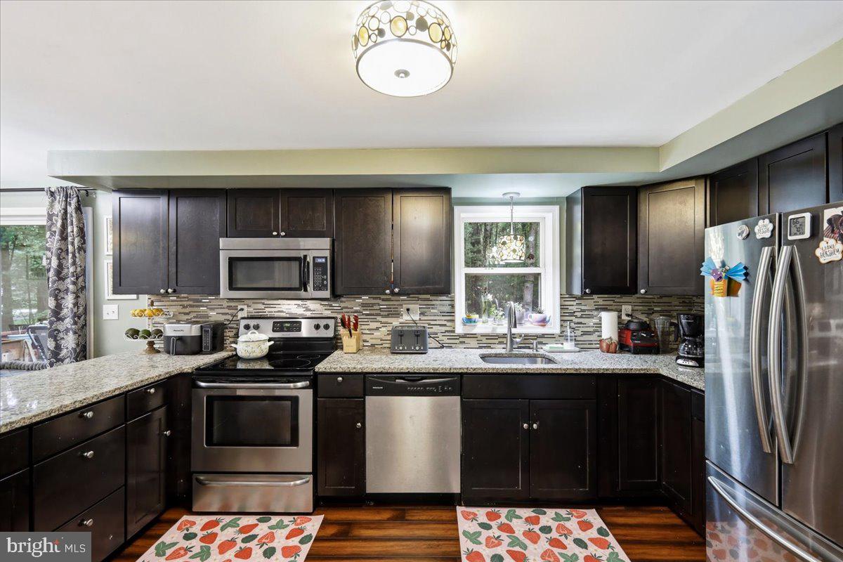 Enjoy the ease of ranch-style living in this beautifully maintained 2,400-square-foot home featuring 3 bedrooms and 2 full bathrooms. The fully finished lower level offers incredible additional living space, complete with a bonus room/office, making it perfect for working from home, guests, a playroom, or a home gym. You'll also find ample storage throughout the lower level. Recent updates include fresh interior paint, a new front entry staircase, a new side porch, and a brand-new storage shed. A rare bonus--this property is being sold with the adjoining parcel behind the home, providing added privacy and bringing the total property to just under one acre. Located in Pleasant Valley Estates within the Pleasant Valley School District, residents enjoy amenities including an outdoor swimming pool, parks, pavilions, playgrounds, basketball courts, kid-friendly activities, and a stocked fishing pond. Just minutes from Pleasant Valley schools, grocery stores, shopping, restaurants, and major commuter routes, this home offers the perfect blend of comfort, convenience, privacy, and community living.